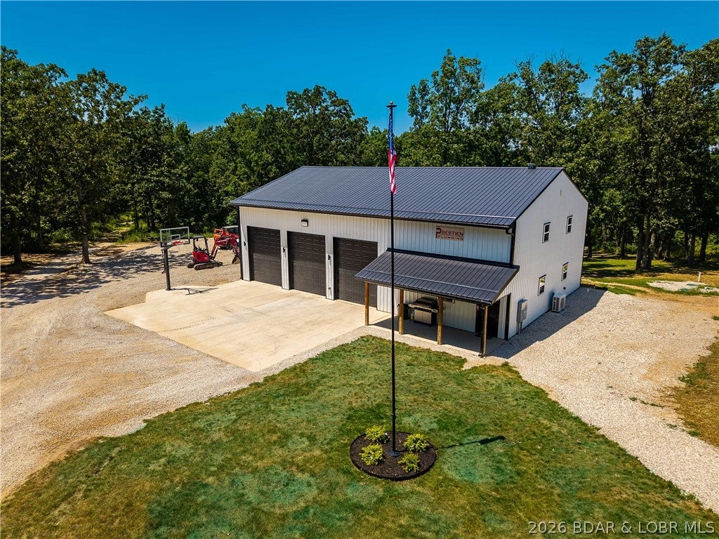 10 ACRES. 60x40 SHOP w/ MAN CAVE. CREEKSIDE SHIPPING CONTAINER RETREAT...PERFECT for deer camp or your own private SXS park! This unique property blends energy-efficient living, serious shop space & outdoor recreation into one impressive package. The updated 3 bed, 2 bath, 2200 sq ft., energy efficient, earth-contact home offers comfortable, efficient living w/ LVP floors, open concept living, large primary suite & walk in closet w/ radon mitigation system. Brand new, spray foam insulated 60x40 shop is impressive with 14 ft doors w/ side mount openers, radiant floor heat, on demand water heater & man cave tricked out w/ live edge bar, surround sound, full kitchen w/ quartz counters & SS appliances w/ a full bath/laundry room & upper apartment/office/home gym. Bring your tractors, RV's, SXS's or classic car collection! Tucked along the trails in the forest on a wet weather creek is a one-of-a-kind shipping container retreat w/ a wraparound deck overlooking the valley, creating the perfect deer camp, hunting headquarters or weekend escape. Located in Eldon school district minutes from town, Coffman Beach boat launch & the Loop II. Under contract w/ 72 hr kick-out.