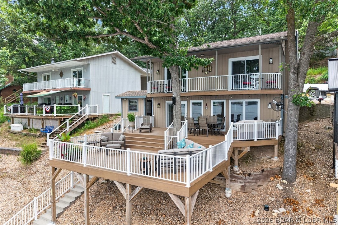 Wake up to phenomenal lake views and start living the lake lifestyle you've always dreamed of! This beautifully updated waterfront home features granite kitchen countertops, updated bathrooms, new windows, doors, roof, and MORE! This fully furnished home offers a light, bright, and airy atmosphere throughout. Expansive windows fill the living spaces with an abundance of natural light, creating a warm and inviting feel. Enjoy relaxing or entertaining on the Trex decking overlooking the water, while the dock with boat lift and storage shed makes lake days effortless. The seamless connection between the indoor and outdoor living spaces creates the perfect setting for making lasting memories. Located in a highly desirable area where vacation rentals are allowed, this property is the perfect full-time residence, weekend retreat, or investment opportunity. Spend your days boating, swimming, fishing, and soaking up everything lake life has to offer! With all of the major updates already completed, this move-in-ready home offers both comfort and peace of mind, you can move in with confidence and immediately begin enjoying everything this exceptional property has to offer.