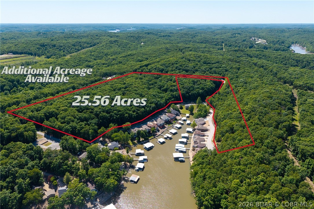 Exceptional 25-acre development opportunity in the highly desirable F-Road corridor of Sunrise Beach at Lake of the Ozarks. This impressive tract surrounds Ledgestone Estates and offers blacktop access directly to the property, making it ideal for future development or a private estate setting. Multiple areas throughout the property feature beautiful lake views of the 26MM, with outstanding potential for second and third-tier homesites—many of which could capture exceptional views with selective clearing. Located just minutes from some of the Lake’s most popular waterfront bars, restaurants, marinas, and Woods Grocery/Gas Station, this property combines convenience with tremendous investment upside. Large acreage parcels with this kind of location, accessibility, and development potential are becoming increasingly difficult to find at the Lake. Whether you’re looking to develop, invest, or create a private retreat, this property offers endless possibilities in one of the most sought-after areas of the Lake of the Ozarks. Additional acreage is available and would make 60 contiguous acres