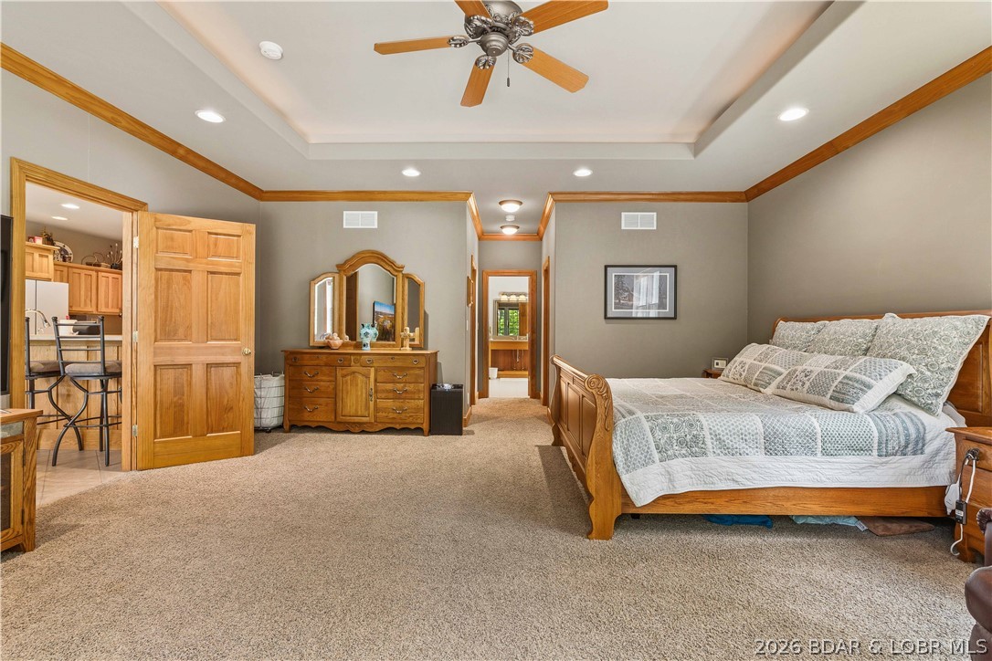 Welcome to this incredible home nestled on 6 gentle acres in the highly sought-after Lake of the Ozarks State Park, offering the perfect blend of comfort, privacy, and functionality. This 4-bedroom, 3.5-bath home features over 5,000 sq. ft. of thoughtfully designed living space. The vaulted living room is filled with natural light and complemented by two wood-burning fireplaces, while the spacious kitchen offers a walk-in pantry and seamless flow for everyday living. The oversized primary suite features dual walk-in closets, a jetted tub, walk-in shower, and direct laundry room access. Upstairs, Jack-and-Jill bathrooms add convenience, while the expansive lower level with soaring ceilings provides endless possibilities. Outside, enjoy the wraparound porch with a screened-in section perfect for watching deer and wildlife. A 3-car attached garage, 30'x50' detached shop, and abundant storage provide room for vehicles, hobbies, and lake toys. Just 12 minutes from Osage Beach with blacktop roads, no HOA, and unmatched privacy, this property truly has it all! Call today to make it yours!