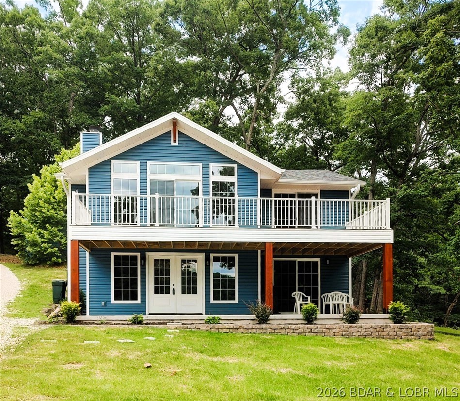 OPEN HOUSE- 12-4 PM - SATURDAY JULY 25 & SUNDAY JULY 26-NEW PRICE- for this beautiful lakefront home feels like brand new. Recently rebuilt top to bottom delivers quality craftsmanship inside & out. All the work has been done & ready to move in. Step inside the well designed floorplan for lakeviews & high end details. Open main level living room spans the entire front of home with wall of windows & fireplace . Spacious kitchen, upgraded cabinetry, granite counters, bar, SS appliances & laundry room. Staircase opens up to vaulted ceiling familyroom, main bedroom suite, 2nd bedroom & half bath. Exterior door to back yard deck. One nonconforming BR for guest/office. Sun filtering through the trees makes it easy to find wood for the fireplace. Green grass & landscaping gives an easy stroll, no stairs to 2 well boat dock. Level lakefront & sandy beach is hard to beat & find at the lake making this property dog & kid friendly. 100 ft +/- at waters edge just over a half acre & water depth for all the seasons. 20x18 metal garage/shop w/electric & shed. End of road with parking for family & friends privacy & space in a cove protected with main channel view. Home faces east to enjoy sunrise.