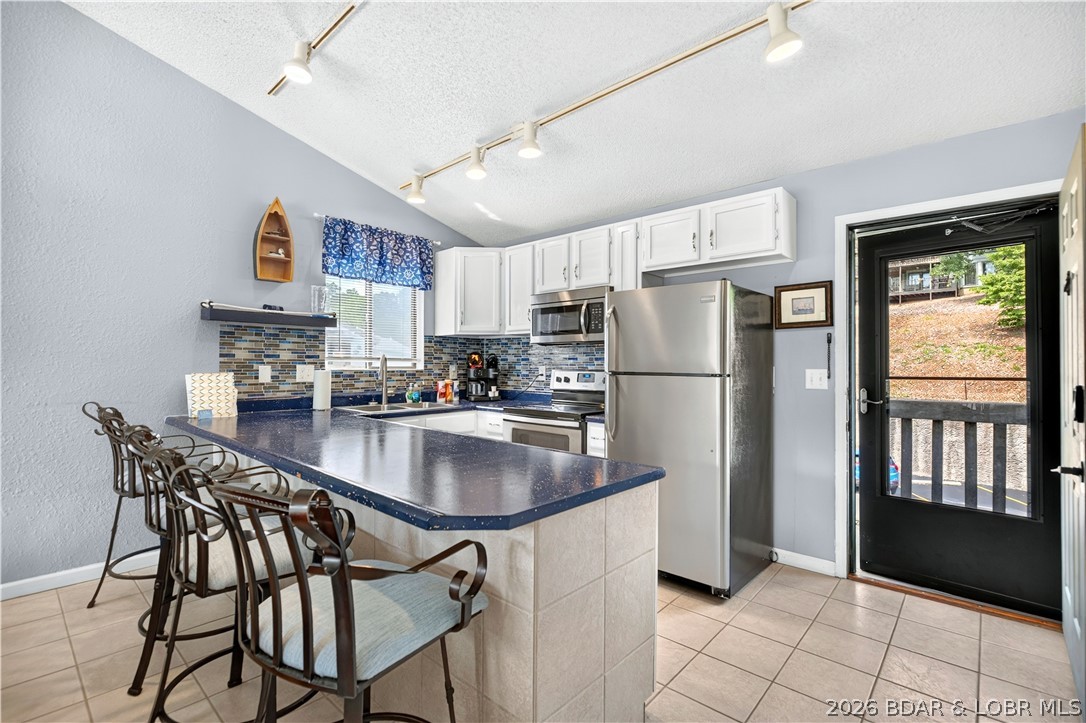 Enjoy the Lake lifestyle without the maintenance in this 2-bedroom, 2-bath top-floor, end unit condo at Southwood Shores! The vaulted ceilings create an open, spacious feel, while the top-floor location offers added privacy and abundant natural light. Whether you're searching for a personal lake retreat, a full-time residence, or an investment property, this condo checks all the boxes. It boasts an impressive nightly rental history with 201 booked nights in 2025, making it an excellent income-producing opportunity. The unit is in good condition and is ready to enjoy from day one, with the opportunity to add your own personal touches over time. A 10x28 boat slip is included, making it easy to spend your days on the water. Southwood Shores is one of the Lake's most amenity-rich communities, featuring a boat ramp, indoor pool and hot tub, outdoor lakeside pool overlooking the main channel, tennis/pickleball court, basketball court, playground, and beautifully maintained grounds. Spend more time enjoying the Lake and less time worrying about maintenance in this turnkey condo!
