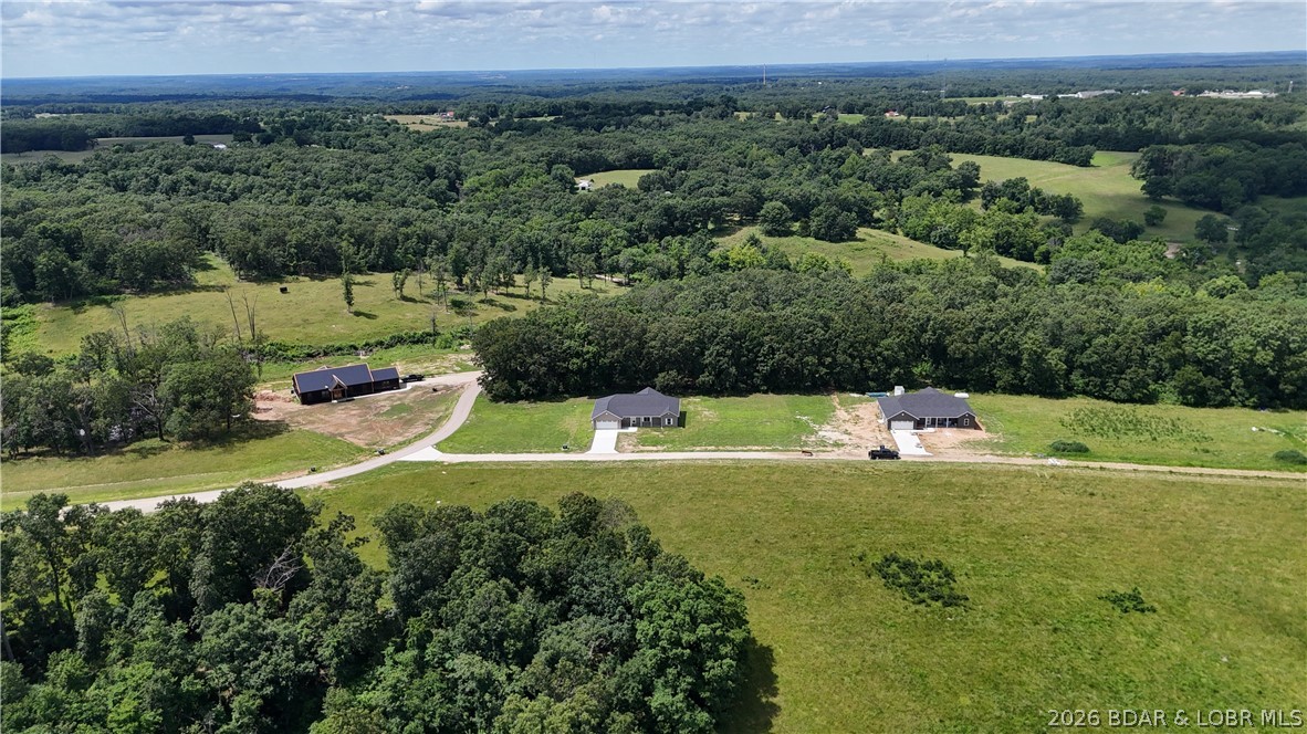 Welcome to 3 Oak Tree Lane! This new construction home offers approximately 2,016 sq ft with an open floor plan set on 3+ acres. The spacious kitchen, dining, and living areas feature a seamless open-concept design—perfect for everyday living and entertaining. The large primary suite includes an exquisite bathroom with dual vanities, a walk-in shower, a private toilet room with pocket door, and his-and-hers closets. Two additional bedrooms provide flexibility for family or guests. Large laundry roomEnjoy the outdoors from the covered front porch or the covered back deck overlooking the woods. Home features stainless steel appliances, all-electric utilities, private septic, shared well, and shared road access. Located in an area of newer homes within a growing community known for strong employment opportunities and a highly regarded school system. Photos of finished rooms are from a previous build and represent the builder’s typical quality and craftsmanship.