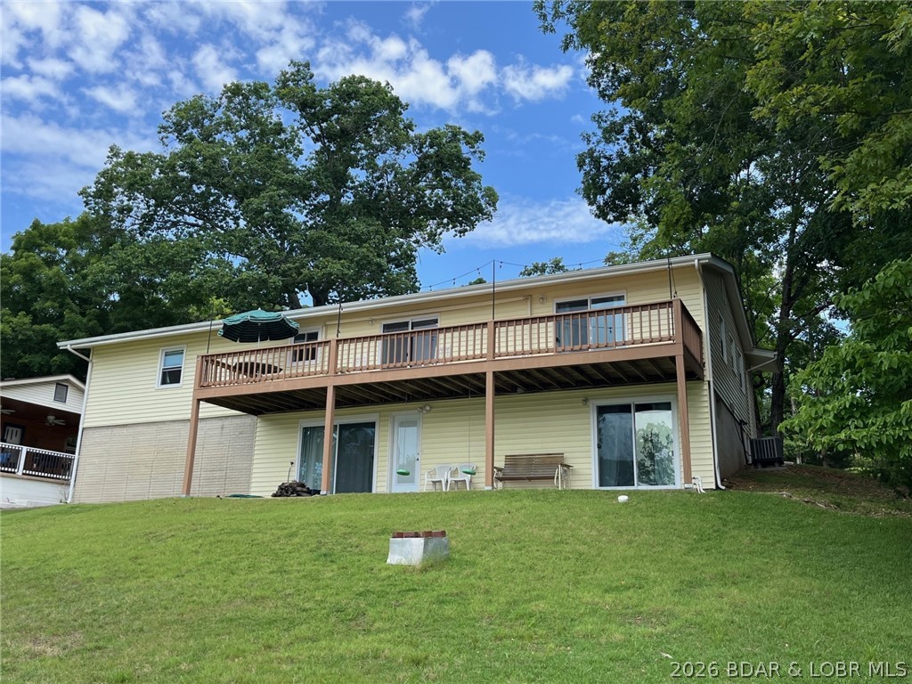 Enjoy a superb main channel view without the rough water at the 48 mile marker!  Nothing left to do but enjoy this completely remodeled lakefront beauty!  It has had a new roof, HVAC, plumbing, electric, drywall, doors, windows, flooring, & more.  Completely updated kitchen and bathrooms.  Four conforming bedrooms & two full baths.  It has all the finishing touches, including Bluetooth in the bathrooms.  The main level has a kitchen, living room, two bedrooms, and a full bath.  The finished basement has a large rec room, laundry, two bedrooms, & a full bath.  Great lakeside views from bedrooms, patio, and the expansive 40’ deck.  Blacktop all the way to the property!  Large, gentle lot and maintenance free siding.  Dock in deep water with a 26’ slip with boat hoist, two jet ski pads, & small ramp.  How about a deep 2 car attached garage to go with it?  Minutes from Boondocks, Red Fox, & Big Dick’s Restaurants on the water.  Close to Station 46 for easy fueling or a ramp.  Community well with no monthly water bill!  Well-maintained neighborhood & great neighbors in the Oak Point Subdivision.  Experience top notch lake living and a breathtaking view! Seller is a Missouri Owner/Agent.