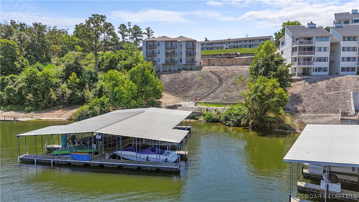 Discover the perfect blend of comfort, convenience, and lakefront living with this newly updated, cozy 2-bedroom, 1-bath condo in the heart of Osage Beach. Ideally located near top-rated restaurants, shopping, attractions, and nightlife, this gem places you in the middle of all the Lake of the Ozarks has to offer. Just steps away, your 12x32 boat slip on the community dock at the 19 MM ensures effortless access to the water. Take in breathtaking main channel views from your covered back deck – the ultimate place to unwind. Already a successful Airbnb with a proven rental history, this property is ready to generate income or become your personal lake getaway. Whether you're seeking an investment opportunity, a weekend retreat, or your very own slice of lake life, this condo checks every box. Location, views, and lifestyle – it doesn’t get better than this!