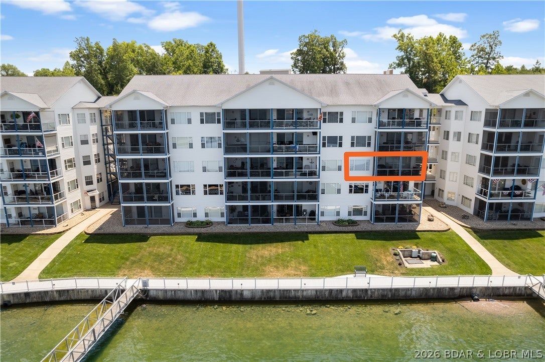 EXCEPTIONAL! One word describes this INCREDIBLE unit's VIEW & Updates! 14 x 40 SLIP! Beautiful Custom Cabinetry (incl. a Custom Murphy Bed & Desk), LVP and Plenty of Storage! A Large Tiled, Screened Deck is yours to enjoy the Lake Life! Located at the beginning of the Gravois Arm at Lake of the Ozarks, nestled in a quiet, deeper cove area that has easy access to restaurants, gas docks and the main channel. 2 swimming pools (1 fresh, 1 saltwater) 2 dedicated swim platforms (1 with kayak launch), an exercise facility, fenced playground (with basketball & pickleball courts), and some of the best fishing at the lake will surely keep your family and guests entertained!  The well lit and maintained dock is equipped with features like water, electric, security cameras, ship/shore power and fish cleaning stations. This complex is meticulously manicured and pet friendly! The boardwalk is great for evening strolls and enjoying the lake views! Friendly neighbors and events are just some of the reasons that make Blue Anchor Bay one of the most sought after condominium destinations at Lake of the Ozarks! Located within Minutes of Restaurants & Entertainment by Boat! OPTIONAL GARAGE & PWC SLIP!