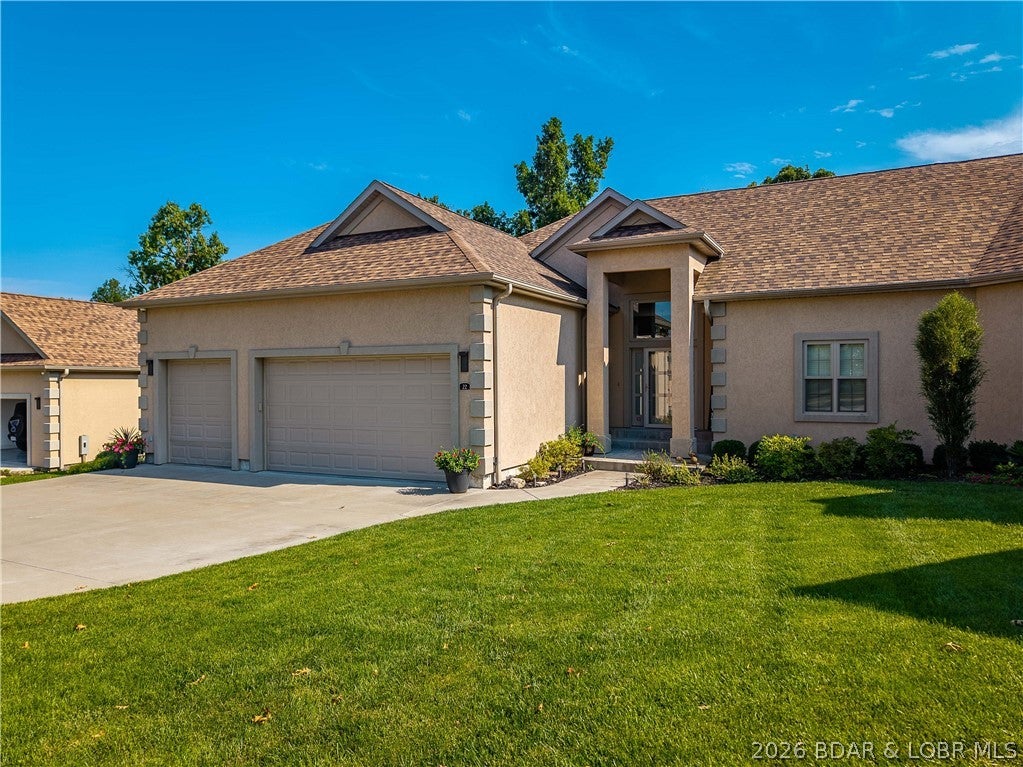 Welcome to one of the premier villas in Bella Terra! One of the newest and largest units in this gated community, this luxury villa offers an impressive combination of space, quality, storage, and beautiful cove views. Designed for main-level living, the open floor plan features 9-12' ceilings, Andersen windows, 8' sliding glass doors, and upscale finishes throughout. The chef's kitchen is built for entertaining with stainless appliances, gas range, pot filler, custom cabinetry, quartz countertops, and a large island. The spacious primary suite features a walk-in closet and spa-like bath with soaking tub, walk-in shower, and quartz vanities. Enjoy the lake year-round from the four-seasons room or adjoining deck overlooking the peaceful cove. The lower level provides additional living space with a family room, wet bar, 4 bedrooms, and excellent storage. A rare 3-car garage provides room for vehicles, a golf cart, and lake toys. Best of all, a 10'x28' boat slip in the community dock is included just a short walk or golf cart ride away.Home has a 48 hour kick-out.