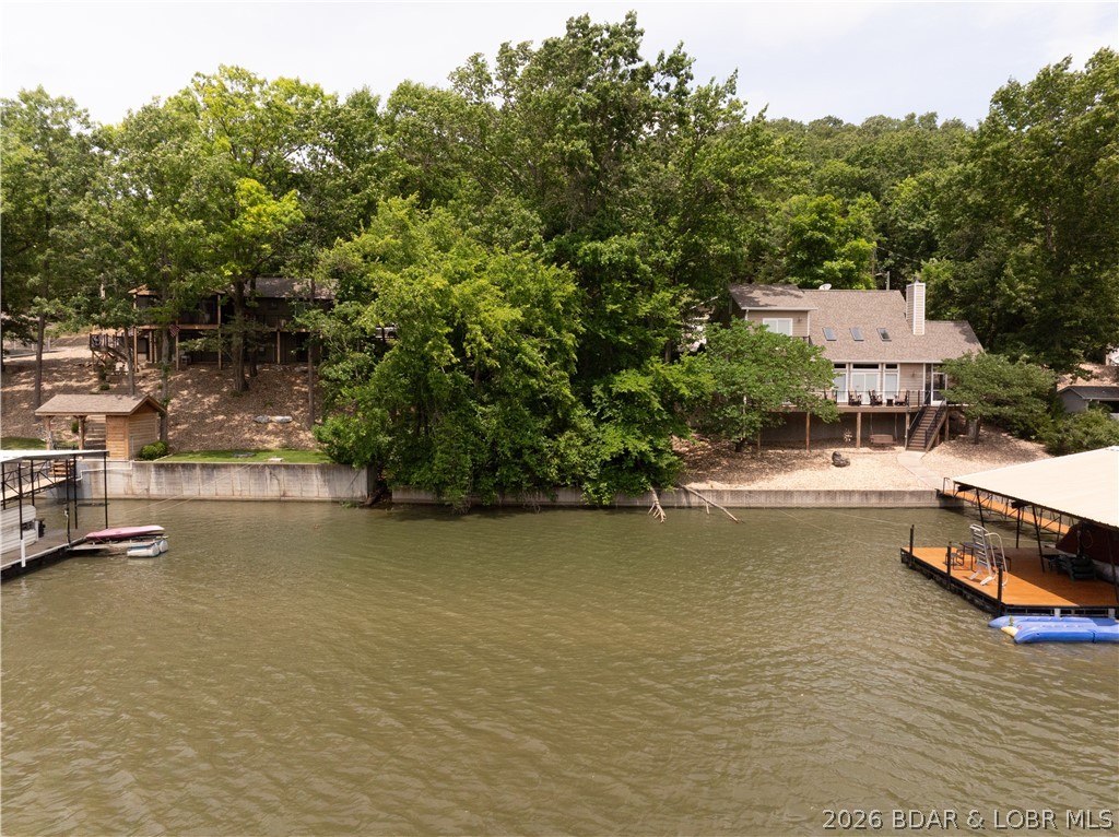 Gentle lot in a nice cove at the 36 mile marker for a great price!  Nice subdivision with quality homes surrounding you.  72 feet of shoreline and a great spot to build your lake retreat!  There is a shared well on the property, seawall is in place and roads already providing good access.  If you have been looking for lake lots you know anything decent is hard to find.  This is the one!  Good water, good roads and gentle topography all at the 36 mile marker of Lake of the Ozarks.  Buy this lot today and start building your future.