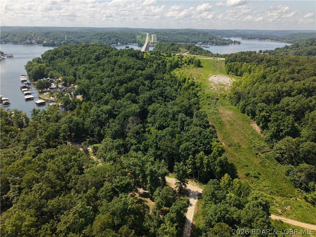 Discover the natural beauty of this 4.2-acre wooded tract in the Twin Rivers Point area near Greenview. Tucked just beyond the back of the cove off Venus Road, this unique property features a creek winding through the landscape, creating a peaceful setting unlike most nearby parcels. Whether you're looking for a place to build, a recreational retreat, a weekend escape, or a long-term investment, this property offers the flexibility to bring your vision to life. Owners enjoy shared community lake access, giving you the opportunity to enjoy the Lake of the Ozarks without the cost of waterfront ownership. Conveniently located near marinas, restaurants, golf courses, and outdoor recreation, you'll have easy access to everything the lake area has to offer while enjoying the character of a property shaped by nature. Seller prefers seller financing terms, creating an excellent opportunity for buyers seeking flexible financing options. If you're looking for acreage with a little more personality than the typical wooded lot, this one deserves a closer look.