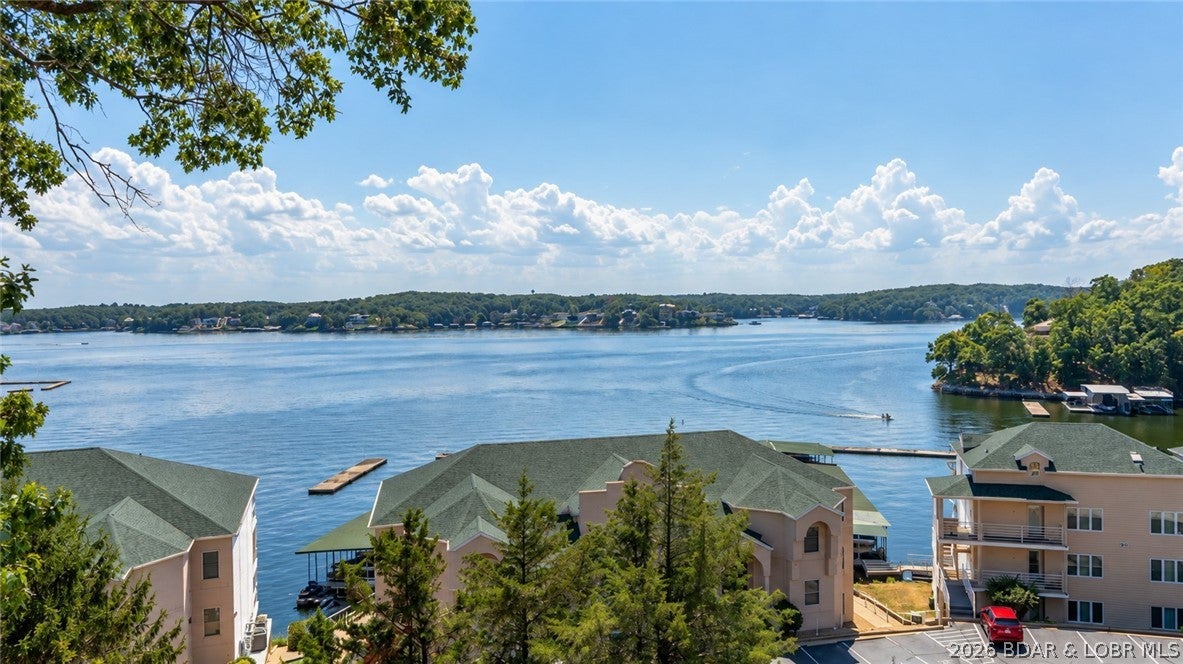 BIG VIEWS, PROTECTED SLIP & READY FOR LAKE LIFE! Enjoy impressive main-channel views from this furnished 2-bedroom, 2-bath condo at Emerald Bay. The open living, dining and kitchen area keeps the lake in view and flows right out to the covered deck, the perfect spot for morning coffee, evening cocktails or watching the boats go by. The kitchen was updated in 2022, while a primary bath update and NEW HVAC in 2026 add comfort and peace of mind. Your 10x32 boat slip is located in a protected cove, giving you convenient lake access without the main-channel exposure. Emerald Bay offers community pools, clubhouse and tennis courts, with cable and internet included in the assessments. Nightly rentals are allowed, giving you the flexibility to enjoy it as your personal lake getaway or explore rental potential, although this unit has never been used as a rental. Located at the 14 MM and just minutes from the heart of Lake Ozark. Come for the view, stay for the lifestyle!
