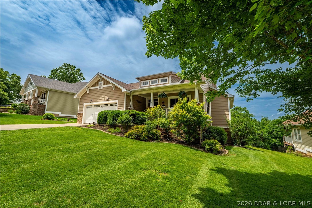 Located in a highly sought-after gated, golf cart-friendly community with incredible amenities, this beautifully designed Craftsman-style home offers over 3,500 sq. ft. of living space in the desirable Camdenton School District—less than 10 minutes to schools and shopping! Residents enjoy a true neighborhood feel with a clubhouse, pool, tennis/pickleball courts, and street lighting. This spacious 4-bedroom, 4-bath home showcases quality finishes including granite countertops, hardwood flooring, stainless steel appliances, tile backsplash, coffered ceilings, and a warm gas fireplace. The expansive primary suite offers a private retreat with a sitting area and spa-inspired bath featuring a jetted tub. Designed for relaxing and entertaining, enjoy the impressive 438 sq. ft. screened porch with composite decking and a cozy gas fireplace just off the dining area—perfect for year-round enjoyment and beautiful views. The lower level features a second family room, full kitchen/bar, and access to a covered concrete patio and flat backyard. Beautiful landscaping and an automatic irrigation system complete this exceptional home offering comfort, convenience, and community living