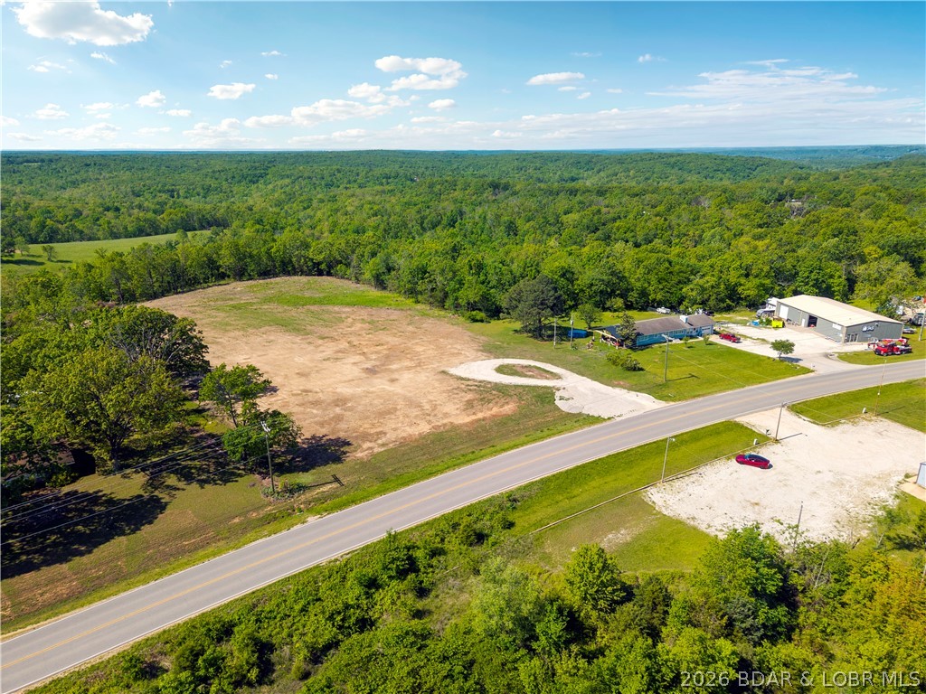 Prime commercial or multi-family parcel in the heart of Camdenton, positioned directly on S Business Route 5 with high-visibility highway frontage. This 1.42-acre front parcel sits just 2 miles from the Camdenton square and less than half a mile to the new Highway 5 interchange — offering exceptional traffic exposure and access that is increasingly rare this close to town. Zoned B2 General Commercial, this lot is level, road-ready, and primed for a wide range of uses including retail, office, multi-family development, or professional services, storage buildings. Seller is open to redivide, build-to-suit, and flexible arrangements. Opportunities with this kind of location, visibility, and versatility at this price point are tough to find. All lot lines are approximate and not currently divided-open for all possibilities.