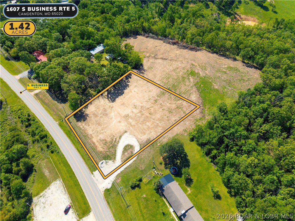 Prime commercial or multi-family parcel in the heart of Camdenton, positioned directly on S Business Route 5 with high-visibility highway frontage. This 1.42-acre front parcel sits just 2 miles from the Camdenton square and less than half a mile to the new Highway 5 interchange — offering exceptional traffic exposure and access that is increasingly rare this close to town. Zoned B2 General Commercial, this lot is level, road-ready, and primed for a wide range of uses including retail, office, multi-family development, or professional services, storage buildings. Seller is open to redivide, build-to-suit, and flexible arrangements. Opportunities with this kind of location, visibility, and versatility at this price point are tough to find. All lot lines are approximate and not currently divided-open for all possibilities.