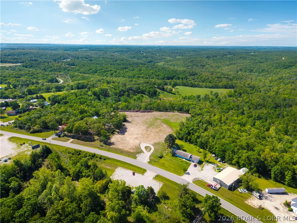Prime commercial or multi-family parcel in the heart of Camdenton, positioned directly on S Business Route 5 with high-visibility highway frontage. This 1.42-acre front parcel sits just 2 miles from the Camdenton square and less than half a mile to the new Highway 5 interchange — offering exceptional traffic exposure and access that is increasingly rare this close to town. Zoned B2 General Commercial, this lot is level, road-ready, and primed for a wide range of uses including retail, office, multi-family development, or professional services, storage buildings. Seller is open to redivide, build-to-suit, and flexible arrangements. Opportunities with this kind of location, visibility, and versatility at this price point are tough to find. All lot lines are approximate and not currently divided-open for all possibilities.