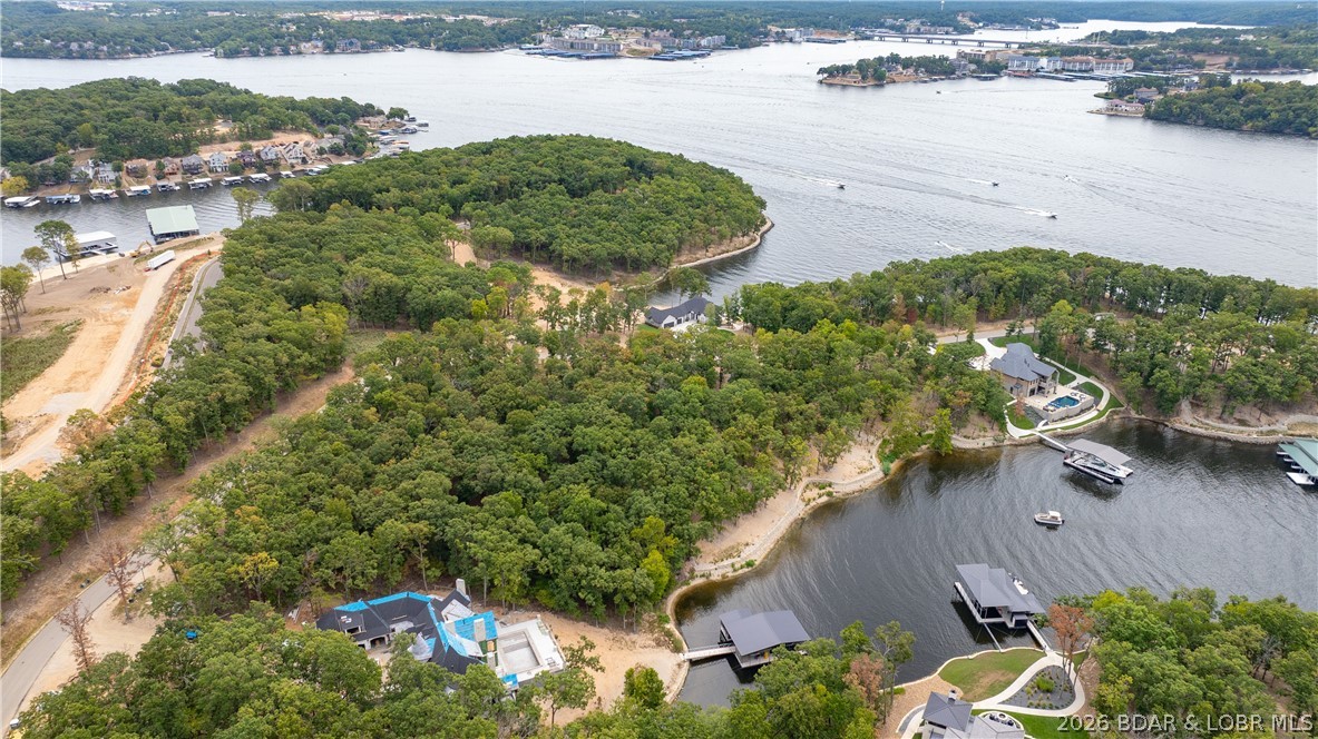 If you want the most exclusive address at Lake of the Ozarks, this is it! This peninsula in the Villages is quickly becoming known as "the ultimate lake address" With over an acre of gentle terrain and 220' of beautiful shoreline, the possibilities are unlimited. Large dock envelope is perfect for the dock of your dreams. Multi-million dollar homes are being built all around this spectacular setting. Everything you need is just across the community bridge. Only minutes from fun activities on Bagnell Dam, multiple groceries stores, shops, restaurants and medical facilities by land offers convenient living. Hop in the boat and you can be at multiple water entertainment complexes including Dog Days, Redhead Yacht Club, Backwater Jacks and for that fine dining experience check out the Reserve! Combine this with the adjacent lots (MLS 3587265) and you have the perfect place to build your lake masterpiece! Don't miss the opportunity to own one of the last premier parcels at the Lake.