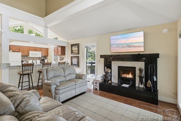Discover this exceptionally well-maintained 3-bedroom, 3-full-bath home featuring lake views & a convenient 2-car garage, which is finished with drywall/paint. Located in TanTarA Estates next to Margaritaville, this beautifully decorated throughout with warm, earth-tone colors, this property invites you to experience true comfort and style. Main level offers an open, welcoming layout, featuring a spacious family room anchored by a cozy wood-burning fireplace, a well-appointed kitchen, and a dining area perfect for entertaining. Step outside to enjoy the serene views from your screened-in porch or relax on the deck. The main level also hosts the primary master suite, providing easy, single-level accessibility. The lower level expands the living space significantly, offering two additional large, spacious ensuites & a dedicated laundry area. This home is being sold partially furnished, making it move-in ready for its next owner. Recent upgrades & maintenance: Roof replaced in 2022, Exterior painted in 2023 & Water heater replaced in 2026. Hot summer days go to the community pool & cool off. Now take this opportunity to own a meticulously cared-for home with/in credibility features.