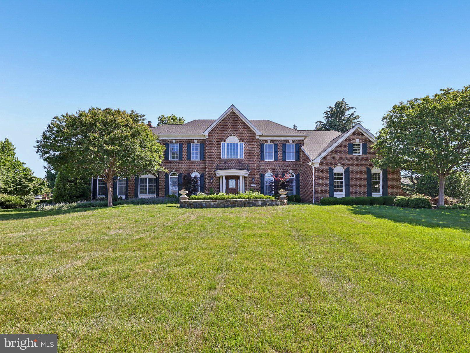 Absolutely extraordinary custom estate offering an unmatched combination of luxury, craftsmanship, and resort-style living on one of the largest premium lots in Belmont. 
***
A grand marble foyer welcomes you into an elegant interior highlighted by wide-plank hardwood flooring, custom millwork, detailed decorative finishes, wrought iron stair balusters, and abundant natural light. The thoughtfully expanded floor plan includes multiple custom additions that significantly enhance the home's size, functionality, and appeal.
***
At the heart of the home is a spectacular chef's kitchen featuring premium Viking and Sub-Zero appliances, a six-burner range with pot filler, Advantium double wall ovens, custom cabinetry, stone countertops, and exceptional workspace. The adjoining sunroom addition creates the perfect gathering space with a cozy gas fireplace and picturesque views of the outdoor retreat.
***
The expansive family room features slate flooring, custom built-ins, a gas fireplace, and ample space for entertaining. A richly appointed main-level library with built-in shelving offers the ideal home office or study, while the impressive conservatory addition is surrounded by walls of windows that flood the home with natural light. The formal dining room showcases custom moldings, a tray ceiling, and a butler's pantry complete with wine cooler.
***
The luxurious primary suite is a true private retreat featuring a coffered ceiling, gas fireplace, spacious sitting room, expanded custom closet space, and a spa-inspired bath with heated tile floors, elegant columns, illuminated dome ceiling, oversized shower, and premium finishes throughout.
***
Extensive additions include a three-story expansion creating additional space for the conservatory, golf simulator room, and expanded primary suite closet; a two-story addition adding the sunroom and card room; and a separate two-story addition incorporating an oversized laundry room and additional finished lower-level living space with full bath.
***
The fully finished lower level offers an incredible entertainment experience with a massive recreation room, dedicated theater area featuring a 4K digital projector and Polk Audio sound system, custom wet bar, game room, card room, exercise room, golf simulator room, workshop, den/guest bedroom, two full bathrooms, and abundant storage. All installed audio/visual equipment conveys, including multiple televisions, projectors, speakers, and entertainment systems.
***
Outdoor living is equally impressive. The nearly one-acre homesite has been transformed into a private natural stone oasis featuring extensive hardscaping, a tranquil stream, koi pond, outdoor stone fireplace, built-in stone cooking and grilling area, jacuzzi, mature landscaping, irrigation system, and multiple gathering spaces designed for year-round enjoyment. The setting offers exceptional privacy and one of the largest lots in Belmont.
***
Additional highlights include three gas fireplaces, custom window treatments throughout, epoxy-coated garage flooring, upgraded lighting and fixtures, extensive technology enhancements, and countless custom details rarely found in today's market.
***
Residents of Belmont Country Club enjoy exceptional amenities including Arnold Palmer Signature golf course, modern fitness center with classes, 7 tennis courts, and pickleball, three swimming pools, upscale dining at Lee's Table & Tavern, and year-round social events and community activities. The HOA also provides lawn care, trash and recycling, high-speed internet, and cable TV, making homeownership easy and low maintenance. Prime Loudoun County location convenient access to: Washington Dulles International Airport, Belmont Chase shopping, and dining. One Loudoun lifestyle center and Lansdowne Town Center. With nearby access to the Silver Line Metro and major commuter routes, this location blends luxury living with everyday convenience.