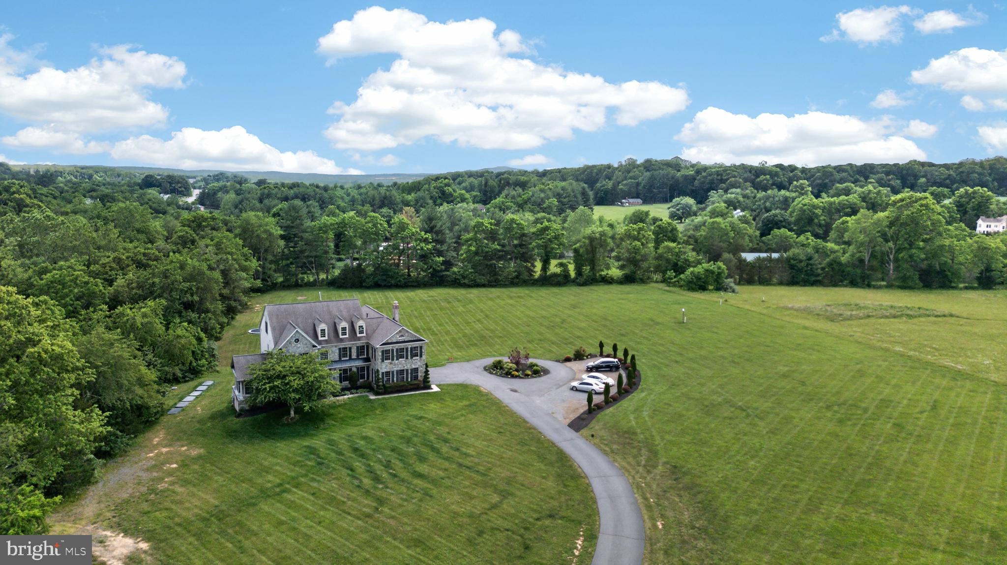 Exceptional 4-level, 10-acre estate in sought-after Long Meadow Hamlet, offering breathtaking conservancy views and 8,000 square feet of meticulously maintained living space. This stunning Craftmark home features 6 bedrooms—including four upper-level bedrooms with private en suite baths a total of 6.5 baths.

The light-filled main level boasts a gourmet kitchen with a large island that seamlessly flows into a spacious family room, anchored by a dramatic floor-to-ceiling stone fireplace. Retreat to the generous primary suite, complete with its own cozy fireplace, or head up to the rare fourth-level loft area—featuring an additional den/bedroom and a full bath. The finished, walk-out lower level is an entertainer's dream, offering a recreation room, a media room with a third fireplace, ample storage, and a private guest bedroom with a dedicated bathroom.

Take in the peaceful country living from the expansive deck while being just minutes from historic downtown Leesburg, wineries, dining, and major commuter routes. A rare combination of privacy, space, and convenience in the heart of Loudoun County.