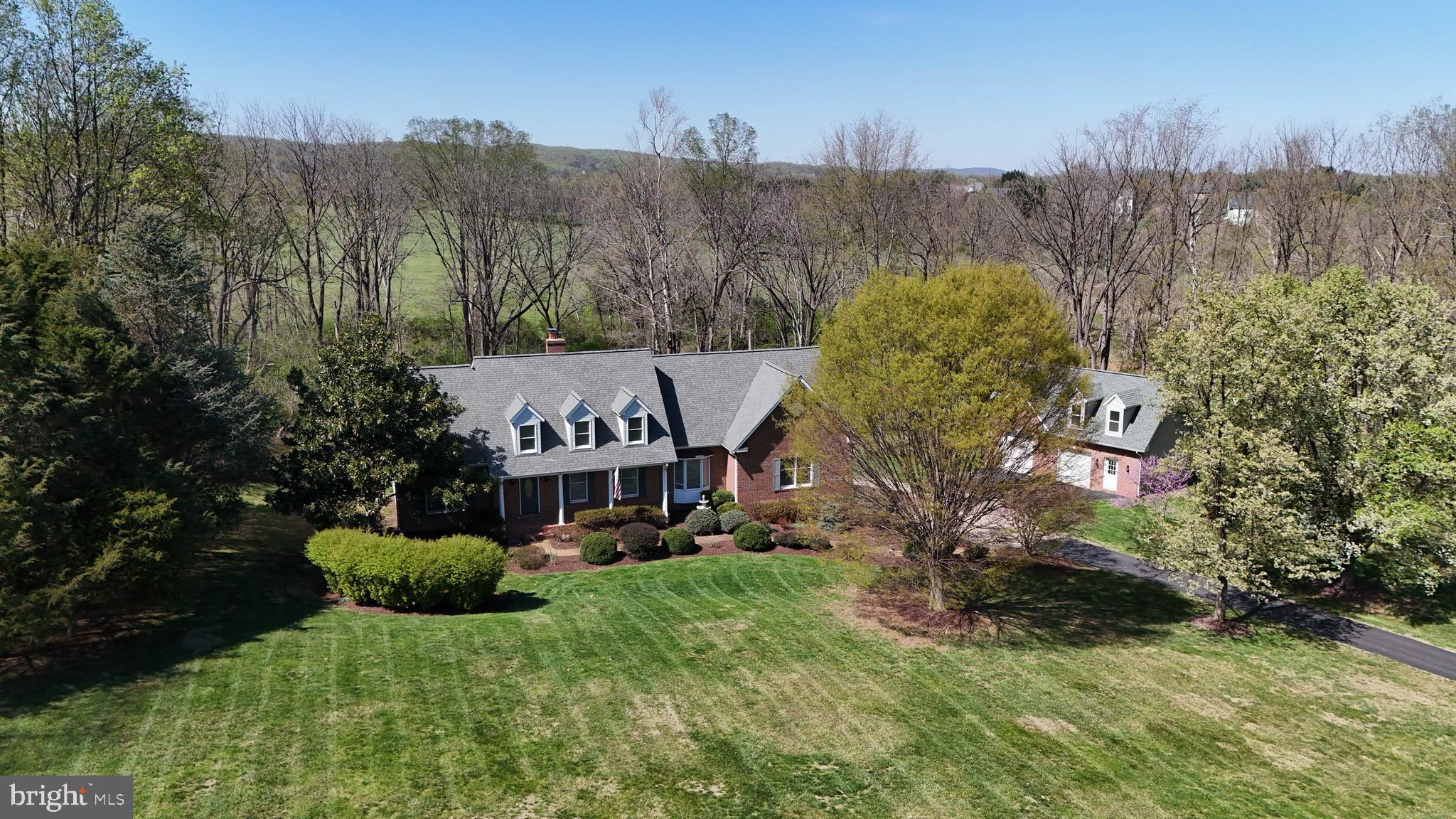 Nestled on 3.6 secluded acres, this stunning 4-bedroom, 4-bath home offers the perfect blend of tranquility and comfort. Surrounded by mature trees and bordered by a picturesque stream, this private retreat provides a peaceful escape while still being conveniently located just minutes to downtown Leesburg.
 Enjoy the convenience of one-level living with a thoughtfully designed layout featuring a spacious primary bedroom with an en-suite bathroom, a dedicated office space, and a comfortable second bedroom with an adjacent full bathroom. This home also offers a well-appointed kitchen, a cozy family room, and a stylish dining area.  An open-concept living area flows seamlessly to a large deck, perfect for entertaining or simply soaking in the serene surroundings. 
For car enthusiasts or those in need of extra storage, this property boasts an attached side-load 3-car garage plus an additional detached temperature controlled 2-car garage with a loft, providing ample space for vehicles, hobbies, or a workshop.
Whether you're seeking a private retreat or a home with generous space for work and play, this one-of-a-kind property is a must-see.