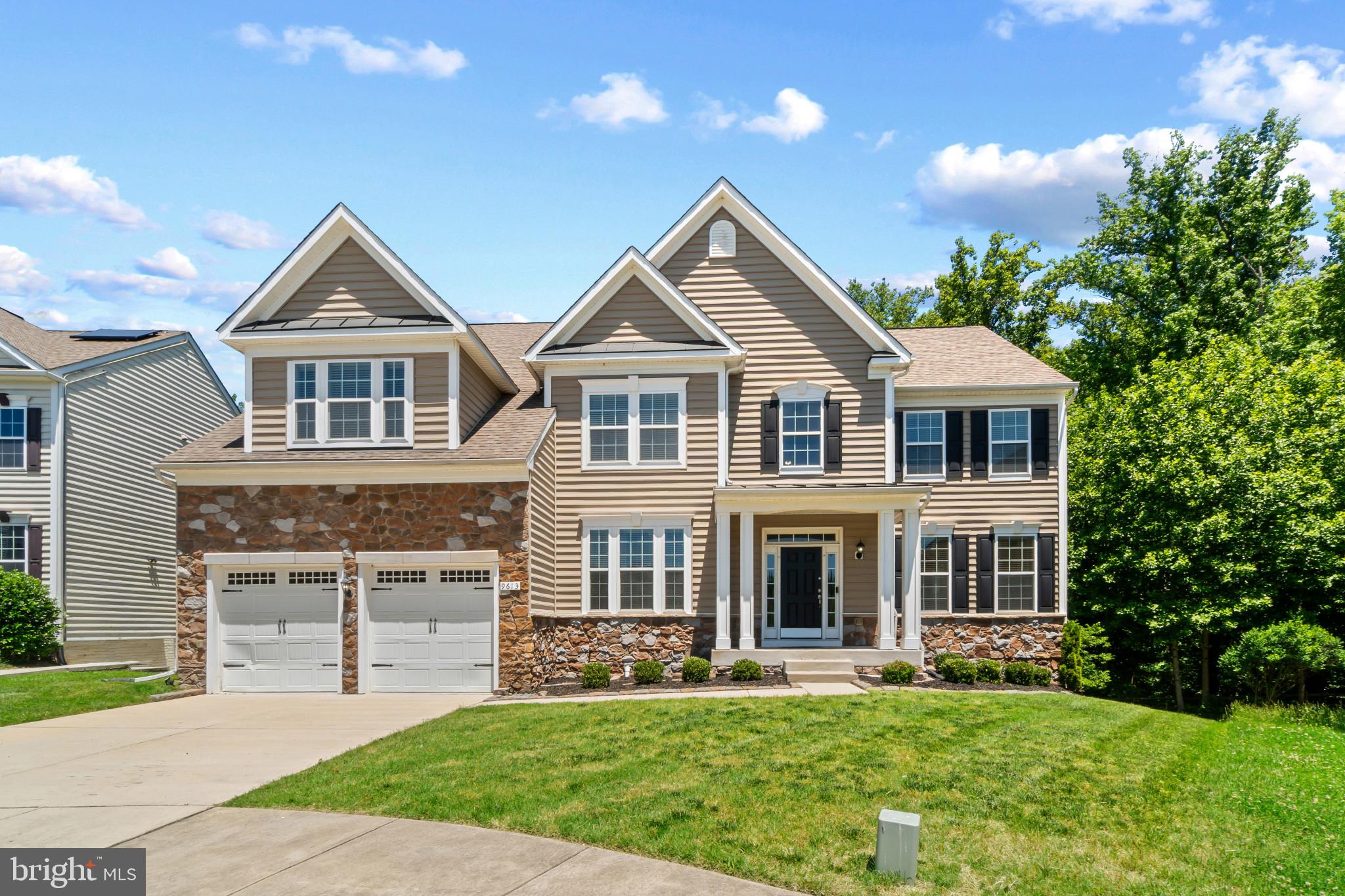 Elegant stone-accented single-family residence nestled on a picturesque cul-de-sac in sought-after Smith Home Farm. Fresh landscaping and a welcoming front porch create exceptional curb appeal, while the light-filled interior showcases recessed lighting, spacious open living areas, and hardwood floors flowing throughout the main level. // A grand foyer sets the tone and is flanked by French doors opening to a well-appointed study, ideal for a home office or library. The formal living room flows seamlessly into the formal dining room, where sophisticated columns and chair rail molding create an elegant setting for entertaining. // The open-concept great room is the heart of the home, featuring a dramatic two-story family room with a fireplace and plush carpeting. The spacious eat-in kitchen is thoughtfully designed with a center island offering breakfast bar seating, rich dark cabinetry, a subway tile backsplash, gorgeous countertops with abundant workspace, stainless steel appliances, a walk-in pantry, and a built-in writing station. The adjoining breakfast /sunroom is bathed in natural light and features a ceiling fan and exterior access, creating a seamless connection between indoor and outdoor living. A convenient powder room and mudroom with garage access complete the main level. // The expansive owner’s suite serves as a luxurious retreat with a private sitting room, an oversized walk-in closet, and a spa-inspired ensuite bath featuring dual vanities, a corner soaking tub, separate shower, and private water closet. Three additional upper-level bedrooms provide comfortable accommodations, including one with a private ensuite bath, while the remaining two share a dual-entry bathroom. A centrally located laundry closet adds everyday convenience. // The finished walk-out lower level offers exceptional versatility with expansive recreation space ideal for a media area, dining space, gaming tables, exercise equipment, play space, and more. A fifth bedroom suite provides excellent accommodations for guests or multi-generational living, while additional unfinished areas offer abundant storage or the opportunity for future customization. // Outdoor living continues on the Trex® deck overlooking the fenced backyard, which backs to mature trees for added privacy and a peaceful natural backdrop. Residents of Smith Home Farm enjoy a desirable setting convenient to shopping, dining, parks, recreation, major commuter routes, and highly regarded Prince George’s County schools. // Select photos have been virtually staged for illustrative purposes only.