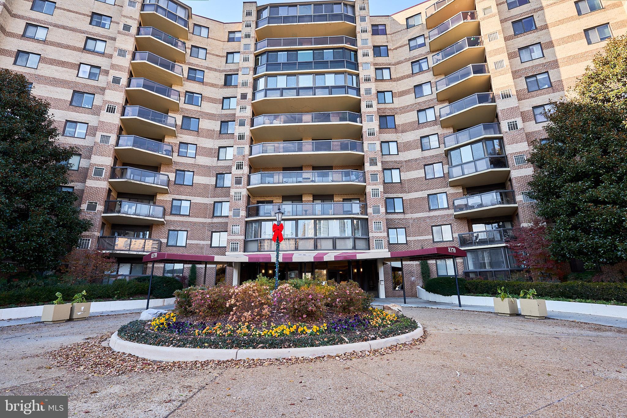 HUGE PRICE ADJUSTMENT IN THE HEART OF TYSONS CORNER!  One of the larger units in The Rotunda complex!  Lovely well-designed condo corner unit in gated community with many amenities and 1,504 well-maintained, finished square feet!  Large light-filled glass-enclosed balcony/sun room with newer motorized blinds.  Spacious living room and 2 comfortable bedrooms open to the balcony.  An adjacent den/office could be converted to a third bedroom with a door addition.  The kitchen features granite counters and great storage  space.  A formal dining room connects kitchen and living room - allowing for easy entertaining!  Two full bathrooms.  Substantial closet space makes downsizing easier! Unit is near the fourth floor elevator for easy access to the lobby and also to the garage assigned parking space and storage area.  (Both garage space and storage area are included!) The 34-acre Rotonda campus has security gates on both sides of the campus that can be accessed day and night and the grounds are patrolled. There are many wonderful features within The Rotonda community including indoor & outdoor pools, spas, game rooms, fitness center, walking trails, picnic & grilling areas, playgrounds, as well as facilities for basketball, volleyball, tennis and a golf putting green. There are also a fenced dog park and several pet-friending areas, car vacuum + car wash + vehicle charging area, community center, business center, convenience store, library, and party rooms.  So many options within the community!  Beyond the gates, there are numerous amenities nearby, including Tysons Corner Center, Tysons Galleria, Capital One Hall, Wolf Trap, first-rate eateries and other great shopping opportunities. The Rotonda is also near major commuter routes -- the Spring Hill Metro Station and public bus service are less than 1 mile away providing access to downtown as well as two international airports . Comfortable living in a secure location!  Is this your next home?