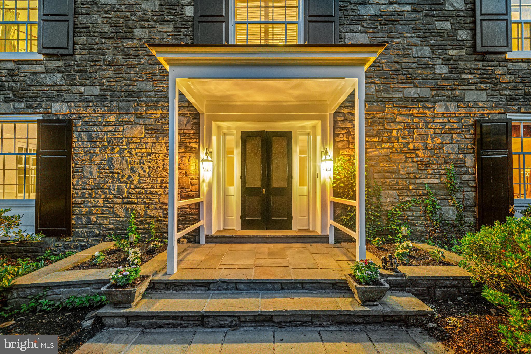 Welcome to 400 Meadowbrook Ave. This charming stone colonial is perfectly positioned on a corner lot in the  desirable South Wayne  neighborhood,! This property features an expansive yard and a true “walk to everything” lifestyle. This residence is just minutes from downtown Wayne, the Radnor Trail, and the Wayne train station. Custom built by local craftsmen in 1956, this home has been lovingly maintained and updated by one owner over the last forty years.  The low maintenance exterior features new Hardie siding, and original stone and stucco. 
Inside light filled living spaces are defined by high ceilings, architectural details and deep set windows.  The large welcoming foyer features custom wainscoting and hardwood flooring that flows seamlessly throughout the main level.  A formal living room centers around a classic fireplace with a detailed  mantel, with French doors leading to the patio.
Off the foyer a hallway flows to the cozy den/family room featuring light painted wood paneled walls, and built in cabinetry - a perfect tv space. French doors from this room lead to the patio. A convenient 1st floor powder room is nearby. The classic oversized formal dining room is wrapped in crown molding and chair rails. Off the back hall a custom walk-in butler’s pantry/wet bar offers wood shelving and is equipped with a bar sink and goose-neck faucet, conveniently serving the den, dining room and kitchen.
 
The gourmet island kitchen features custom white Lancaster County cabinetry installed in 2014, premium countertops, white subway tile and a center island featuring a Brazilian cherry countertop.  High-end appliances include a Thermador professional-grade 6-burner gas cooktop, built-in Thermador wall oven and microwave, integrated Thermador dishwasher, Viking warming drawer, KitchenAid refrigerator, and a deep under-mount Grohe sink. 
A large window over the sink frames views of the fenced in back yard.  Off the kitchen through French doors is a slate sunroom space offering walls of windows.  The sunroom provides direct access to the 2 car garage and doors to the front and back yard.
 
Four bright, airy bedrooms are on the second level.  The Primary suite has a walk-in “California” closet, and large en-suite 4 piece bath bathed in natural light.  Centrally located in the upstairs hallway, an open area features a custom office space with shelving and a built in desk area. The up to date hallway bath features a double vanity, walk in shower and claw foot tub.
 
The lower level features high ceilings that offer endless potential for additional finished living space.  This level includes a second convenient powder room, a laundry area, a stone fireplace, and windows that allow for plenty of natural light.

Located within the top ranked Radnor School district, this home provides a flawless blend of historic Main Line charm and everyday modern living.  Enjoy ultimate convenience with an easy walk to downtown Wayne and a quick drive to Villanova, Radnor, and neighboring towns. Quick highway and train access provide easy commutes. Enjoy the vibrant South Wayne lifestyle with boutique shopping, community events, standout dining, and the nearby Strafford Farmers Market.  This rare South Wayne gem is ready for its next chapter!
