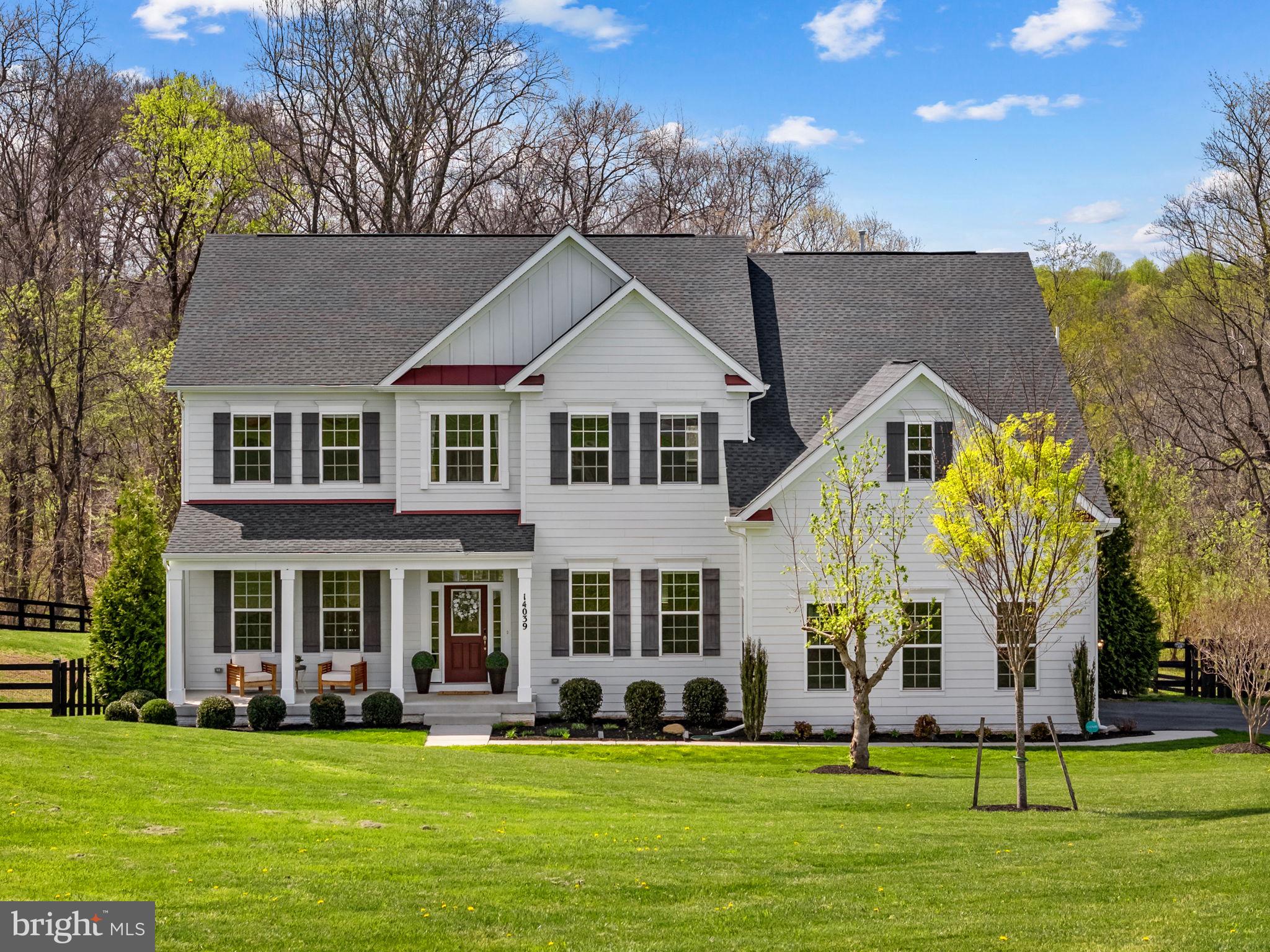 VA Assumable Loan at 2.75%. Inquire for details!Tucked into the rolling landscape of Waterford Manor, this Brookfield Residential Hadleigh model offers a rare combination of scale, setting, and everyday livability. Built in 2021 and spanning over 6,300 square feet across three levels, the home sits on 3.24 acres, where wooded privacy, mountain sunrises, and a natural backdrop create a setting that feels both expansive and deeply personal.

The arrival sets the tone. A long approach and generous driveway create a sense of space and welcome, with room for guests and gatherings alike. From there, the property opens into a landscape that feels more like a private retreat than a traditional homesite. Mature trees frame the rear of the home, and just beyond the property line, a natural path leads to one of the area’s most special features—a 20-foot-wide creek with a dramatic rock face.

In the spring, the experience shifts even further. Bluebells begin to bloom along the path, creating a quiet, fleeting moment of color that feels almost hidden—something you discover rather than expect. It’s the kind of setting that invites you to slow down, whether you’re walking to the water, fishing, or simply taking in the surroundings.

Inside, the home opens with intention, but it’s the great room that defines the experience.

The two-story great room rises at the center of the home, filled with natural light that shifts throughout the day. Tall windows draw your eye upward and outward at the same time, framing the surrounding trees while creating a sense of volume that feels both expansive and calm. It’s a space that feels just as right for quiet mornings as it does for a full house—grounding the entire home in light, scale, and connection.

From here, the layout unfolds naturally. The kitchen sits just beyond, designed to support both everyday living and entertaining, with quartz countertops, extensive cabinetry, and KitchenAid stainless steel appliances. It opens seamlessly to the great room, allowing the two spaces to function as one without losing definition.

A formal dining room and separate sitting room frame the entry, offering more intimate spaces when needed, while a private office and powder room add flexibility to the main level. The rear deck extends the living space outdoors, overlooking the acreage and wooded backdrop.

Upstairs, four bedrooms are thoughtfully arranged to provide both privacy and versatility. The primary suite is especially generous, offering a true retreat with a large footprint, walk-in closet, and a spa-like bath complete with soaking tub and separate shower. One bedroom includes a private ensuite bath, while two additional bedrooms are connected by a Jack & Jill bath. A laundry room on this level adds convenience, and an open overlook to the great room below keeps that sense of connection present throughout the home.

The lower level adds another layer of possibility. With over 2,200 square feet, including a large finished recreation area and additional unfinished space, the layout supports a wide range of uses—media, fitness, guest space, or future expansion with the potential for an additional bedroom and bathroom. The walk-out design provides direct access to the backyard, making the space feel fully integrated.

The capital improvements here are both recent and meaningful. In 2026, the home was freshly painted throughout in McCormick Dove’s Wing, the stairs were professionally stained, and new flooring was added to bedrooms and office. The septic system was pumped in December 2025, and all major systems—including HVAC, roof, windows, electrical, and plumbing—date to the home’s 2021 construction. Featuring Xfinity high speed internet. 

Living in Waterford Manor offers a unique balance of privacy and accessibility. The setting feels quiet and removed, yet you remain just minutes from historic Waterford, downtown Leesburg, and the region’s wineries and countryside destinations.