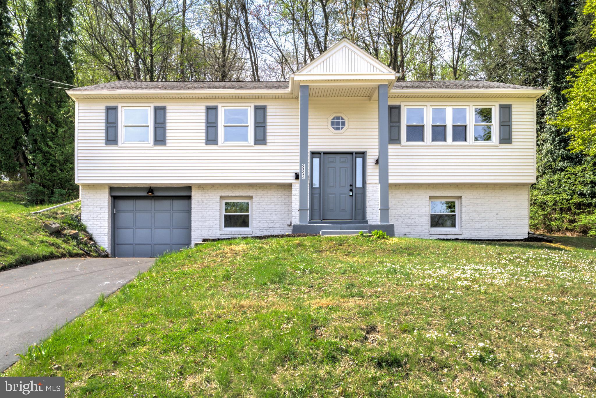 Welcome to this beautifully renovated 4-bedroom, 2.5-bath single-family home located in a desirable residential neighborhood in the greater Philadelphia area. Thoughtfully updated throughout, this home offers a bright and inviting layout designed for comfortable everyday living and gathering! The open concept main living space features durable and attractive luxury vinyl plank flooring, creating a seamless flow and modern feel. The brand new kitchen is a true centerpiece, showcasing all new wood cabinetry, quartz countertops, a stylish tile backsplash, and stainless steel appliances. A center island provides additional dining space and generous prep area. Just off the kitchen, a covered back patio offers the perfect spot to relax outdoors. The main level includes three well-sized bedrooms with all new cozy carpeting and two full bathrooms, including a private primary ensuite complete with a beautifully tiled walk-in shower and tasteful finishes. A second full bathroom on the main level features a tiled tub/shower combination. The finished lower level expands your living space with a large bonus room ideal with plenty of natural light along with a separate room perfect for a 4th bedroom, office, or flex space. A convenient half bath on the lower level adds functionality, and there is easy access to the attached one-car garage. Offering modern updates, flexible living space, and a fantastic location, this move-in ready home is an opportunity you won’t want to miss—schedule your showing today!