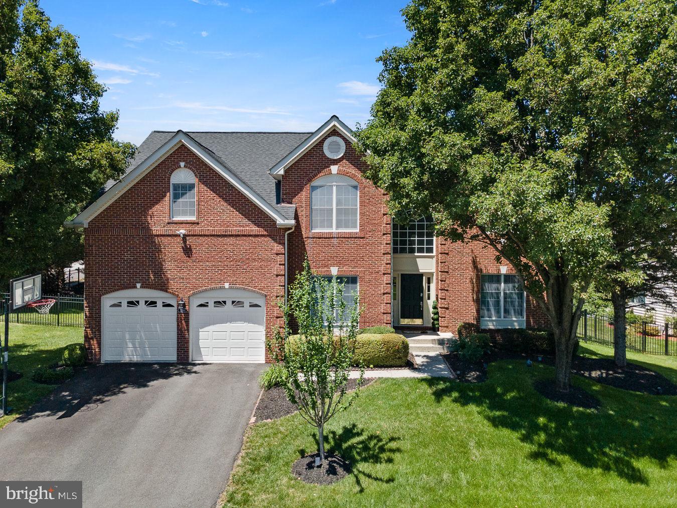 A harmony of classic design and contemporary finishes, this classic colonial home sits in the heart of Ashburn on a quiet, no–thru-traffic cul-de-sac, moments from Ashburn Metro where timeless architecture meets modern comfort in a light-filled residence. With 5,101 total square feet (approx. 4,825 finished) across three levels, the main floor welcomes with an inviting foyer, an open flow through sunlit living and dining spaces, and a spacious family room with fireplace. The gourmet kitchen features granite countertops, upgraded stainless steel appliances, abundant cabinetry, and island seating, opening to a bright breakfast area and an open deck, private patio, and landscaped yard, ideal for everyday living and effortless entertaining. All-level wood flooring enhances the cohesive, elevated feel, and the interior is freshly painted.
Upstairs, the serene primary suite includes a sitting area, a fully customized walk-in closet, and a spa-style bath with dual vanity, soaking tub, and separate shower. Secondary bedrooms are well sized and feature customized closets. The finished walk-up lower level elevates your lifestyle with a complete home theatre setup, a stylish wet bar, laminated wood flooring, a large recreation room, flex office/gym space, a full bath, and generous storage. The attached garage includes a 230V electric car charging point, plus driveway parking. Commuter-friendly and convenient, minutes to Ashburn Metro (Silver Line) with quick access to Dulles Greenway, Loudoun County Pkwy, and Route 50—close to Brambleton Town Center, Loudoun Station, parks, trails, shopping, and dining.
Update highlights: fresh interior paint; new stove and hood (2024); oven and microwave (2021); roof (2020); recently updated HVAC and water heater; whole-house humidifier; irrigation system; 230V electric car charging in the garage.