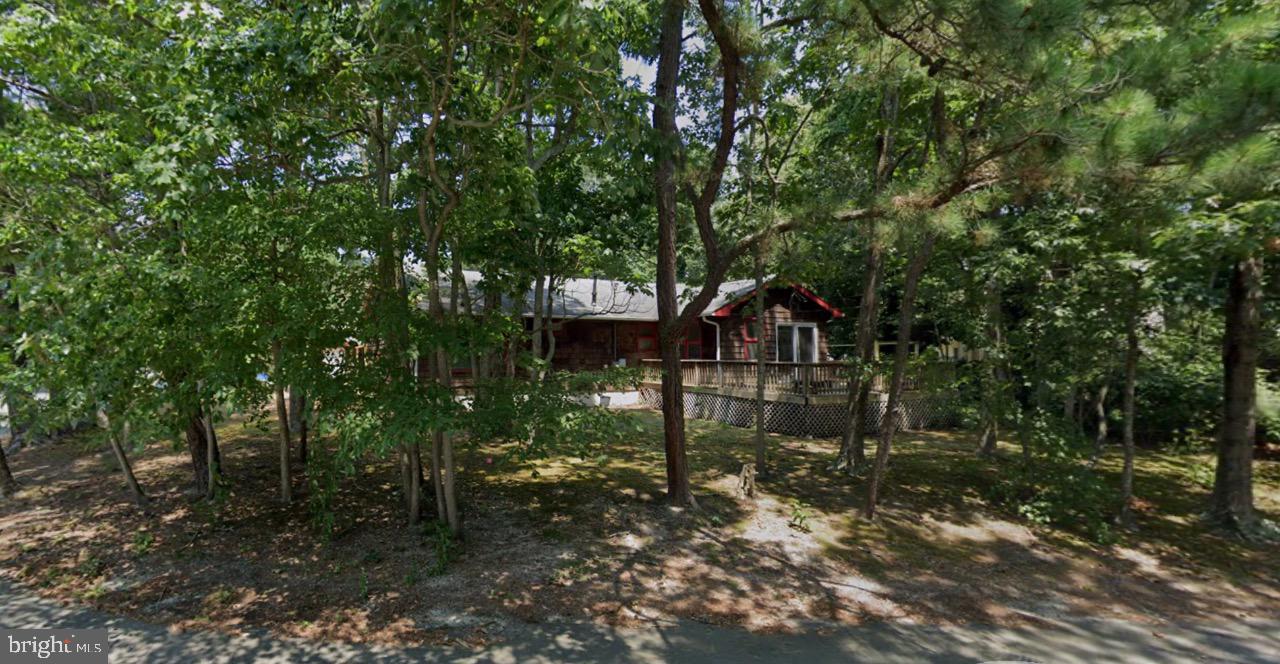 Opportunity awaits in this custom built, open concept home that is full of possibility! This home has great bones and all of the heavy-lifting has already been taken care of in this former rehab, including a new roof replaced the end of 2022, new heating and a.c. (2022), new insulation (2022), closed cell foam on underbelly of house (2024), new maintenance free gutters (2024), new plumbing for washing machine (2025), and on-demand hot water heater — all to provide peace of mind and save you significantly after you move in. With a massive deck already refurbished (2023) and outfitted with a gas line, outdoor heating or grilling is a breeze. The flooring has been redone throughout in stylish wide plank luxury vinyl, including in baths and addition. This home features a reverse osmosis water filtration system and custom blinds, public water and private sewer, tons of storage, AND a pantry off of the kitchen with built-in cabinetry and extra closet, and the living room features a gas fireplace hook-up. A rare added feature is the light-filled addition that leads to a private deck and a custom Palram pergola the current owner used as a pet habitat that will be removed unless agreed to stay, but the possibilities are endless for year-round enjoyment since it also features gas hook-ups. The rear of the property is your private sanctuary where you will find a custom post system that is just waiting for your imagination whether you are a gardening enthusiast, love permaculture, or you are a pet lover, there is room for everyone! The side of the property has been cleared for your convenience expanding usable outside space for recreation or entertaining. With the major systems of the house already updated, this home is ready for your personal touch!