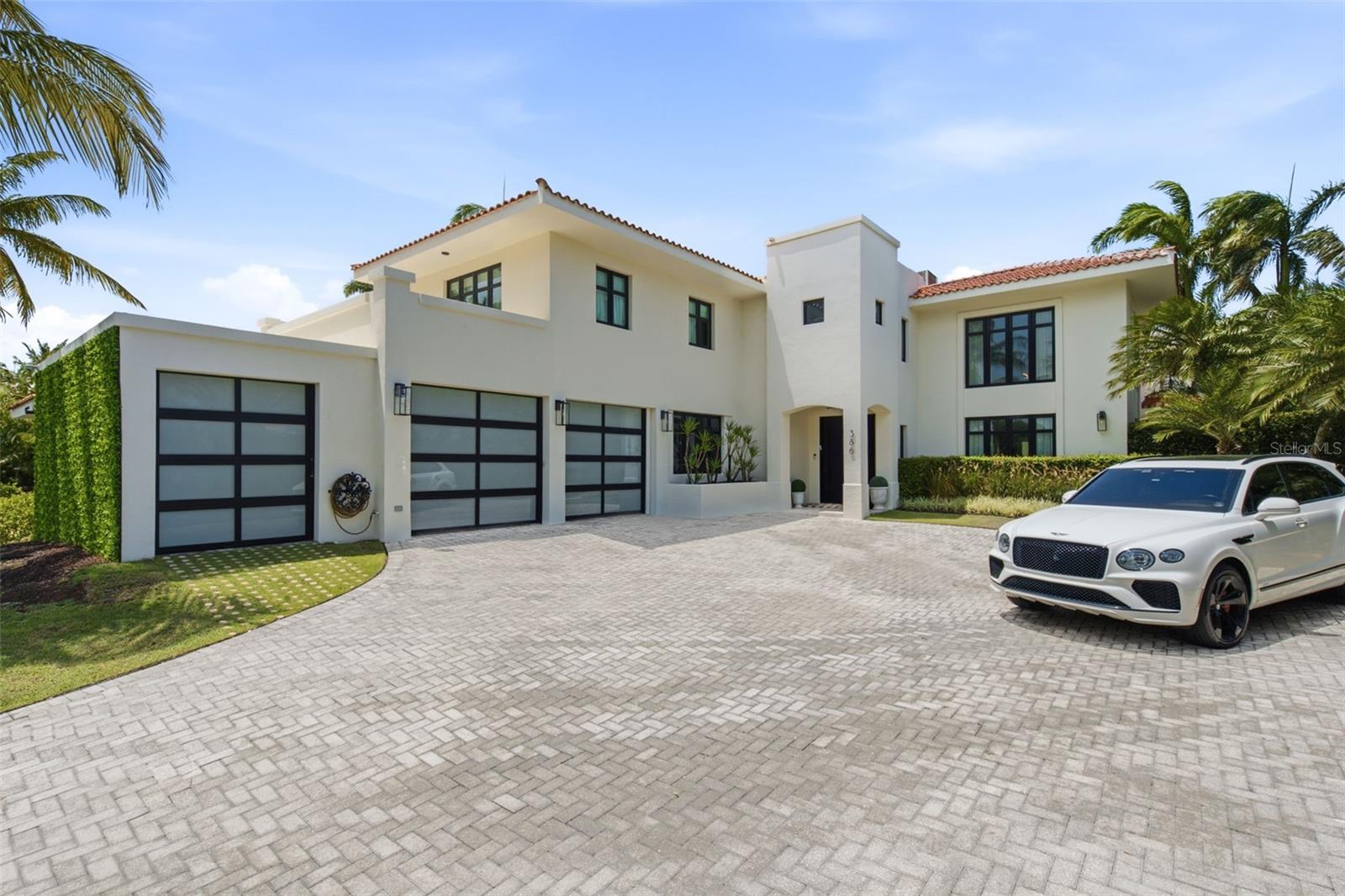 Some homes are memorable. This one is unforgettable.
Designed by Laura McQueen Design, this expanded Dorado Beach East residence offers 5,813 square feet of interior living space on an oversized 0.35-acre corner lot within a private cul-de-sac.
Thoughtfully expanded from its original footprint, the residence now offers five bedrooms, each with an ensuite bathroom, including a first-floor guest suite. The main living spaces are anchored by a dramatic double-height great room, with interiors that balance warmth, texture, and personality.
The home was designed equally for everyday living and entertaining. A custom bar and lounge addition with floor-to-ceiling glass overlooks the pool, complemented by a wine cellar and an expanded pantry with additional refrigeration. The dining room, kitchen, and entertaining spaces flow naturally throughout the home.
Outside, the private pool and tropical landscaping create a relaxed setting for entertaining and everyday living. The home’s coveted northeast exposure welcomes the trade winds and keeps the outdoor spaces naturally cooler through the afternoon, an ideal orientation for year-round living in Puerto Rico.
Recent improvements include a newly sealed roof, new cistern, routinely maintained generator, and refreshed front landscaping, all completed in 2026.
Positioned near the South Gate for convenient access to TASIS and everyday errands, the residence offers an ideal location within Dorado Beach East and Dorado Beach Resort.
