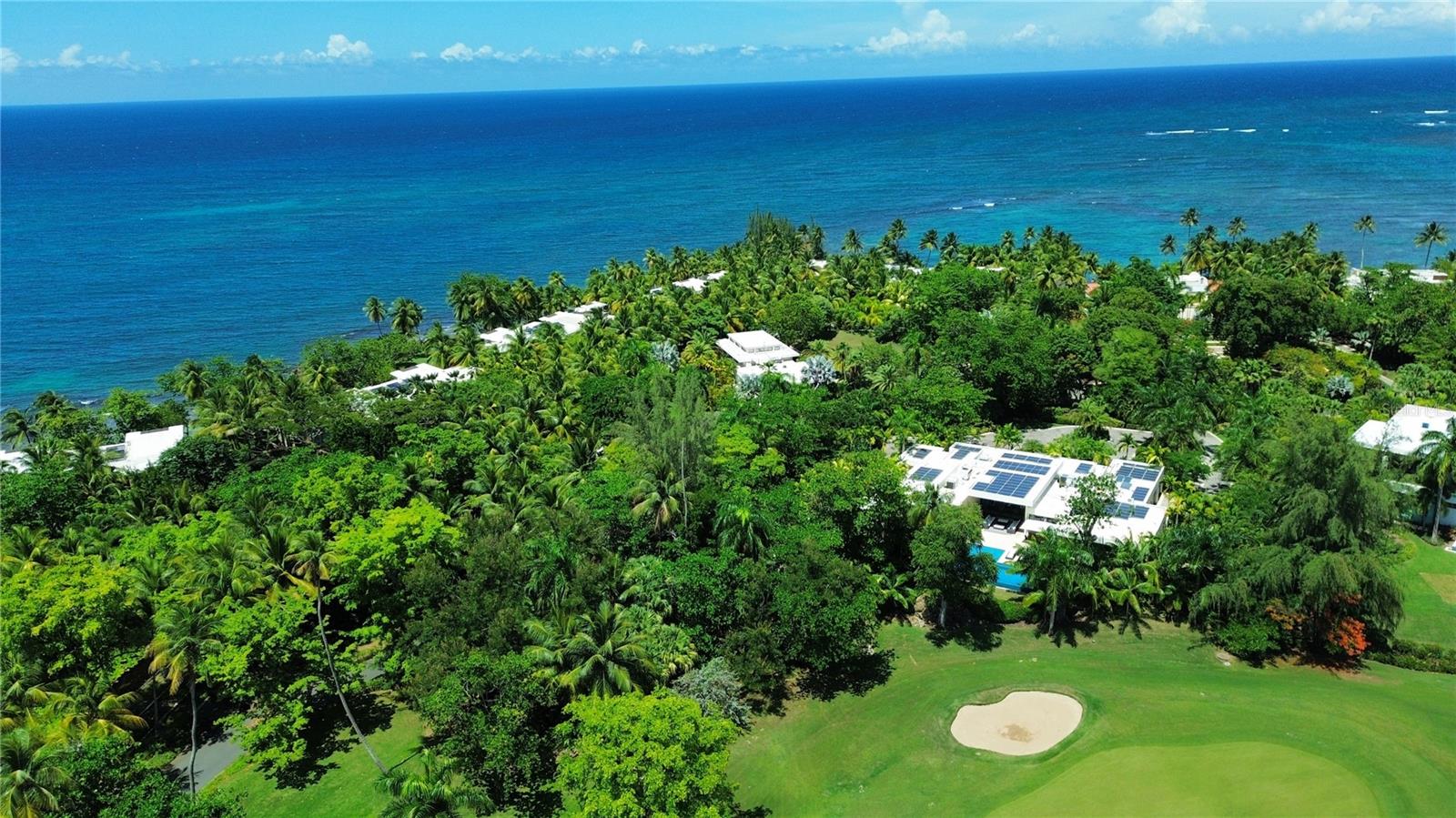 Welcome to one of Puerto Rico’s most iconic and exclusive residences, an extraordinary estate with 5,611 Sq. Ft. of interior space and 7,968 Sq. Ft. in total, located within the prestigious community of East Beach. Nestled on a lush one-acre lot, this Ritz-Carlton Reserve–branded home represents the height of luxury living, blending resort-style design with unmatched privacy and natural beauty.

Guests are welcomed through the home’s main entrance into an open-concept central living room framed by signature walls that echo the refined aesthetic of the Ritz-Carlton. Floor-to-ceiling views of the pool and surrounding gardens create a serene ambiance, complemented by a nearby half bath. Just off the foyer, the dining room flows seamlessly to a garden terrace through expansive sliding glass doors, enhancing the home’s indoor-outdoor living experience.

The gourmet kitchen is a culinary showpiece, featuring a center island with cooktop, built-in mini fridge, and panoramic views of the pool and golf course. Adjacent to the kitchen and living room is a side entrance with a full bathroom and direct access to an outdoor shower, cold plunge, and sauna, bringing spa-level luxury into everyday living.

Each of the bedrooms is uniquely designed as a private retreat. The primary suite is a sanctuary of indulgence, showcasing peaceful views of the garden, pool, and golf course. Its spa-inspired bathroom includes a double walk-in rainfall shower that opens to a lush outdoor garden with a volcanic stone bathtub and outdoor shower. Premium finishes include his-and-hers vanities with an outdoor seating area and a built-in walk-in closet.

On the other side, accessed through the garage, is a private wing featuring an additional bedroom, a full bathroom with a separate entrance to the bedroom, a laundry closet, pantry, and additional storage. Thoughtfully designed, this wing offers privacy and comfort, ideal for visiting guests or multigenerational living.

Ideal for entertaining, the outdoor terrace boasts a fully equipped grilling station and spacious lounge areas centered around a stunning pool and jacuzzi, designed to capture the full beauty of the surrounding landscape and deliver an unmatched resort-style experience.

Perfectly positioned near the entrance to Dorado Beach Resort and steps from Spa Botánico, this property offers both exclusivity and effortless access to Dorado’s most coveted amenities.

Architecturally iconic and rich in luxurious details, this estate is more than a residence, it is a lifestyle, delivering the ultimate expression of refinement that only a Ritz-Carlton branded property can offer.