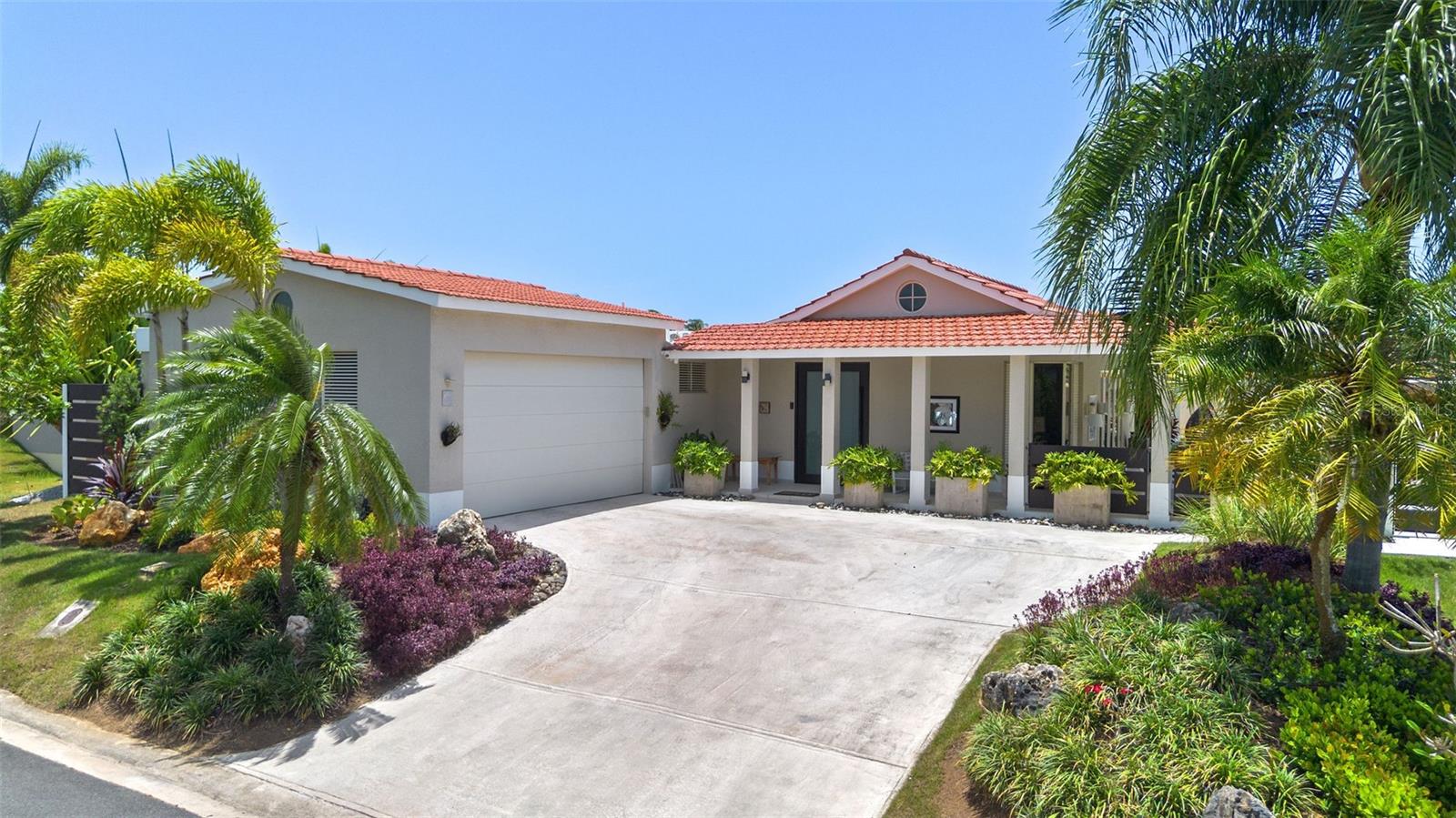 Welcome to this beautifully maintained Casona Reyes residence in the community of Sabanera Dorado, where elegant design, thoughtful upgrades, and exceptional outdoor living come together to create the perfect family home.

Designed for both everyday comfort and entertaining, the home offers an inviting open layout that includes formal living and dining areas, a generous family room, and a charming breakfast room adjacent to the kitchen—an ideal space for casual dining and family gatherings.

Step outside to a private backyard oasis where you can enjoy a beautiful swimming pool, solar outdoor shower, mini golf area, spacious covered terrace, and lush tropical landscaping. One of the home's most desirable features is its orientation, allowing the terrace to enjoy the refreshing eastern trade winds throughout the day while remaining shaded from the afternoon sun, creating an exceptionally cool and comfortable outdoor living space year-round.The professionally designed front landscaping enhances the home's curb appeal.

Additional features include:

Swimming pool with solar outdoor shower
Private mini golf area
Solar water heater
Water softener system
Security camera system
Irrigation system
Beautifully landscaped front yard
Spacious covered terrace perfect for entertaining
Two-car garage with additional driveway parking

Located within the highly sought-after Sabanera Dorado community, residents enjoy a family-oriented lifestyle with 24-hour gated security, parks, walking trails, recreational facilities, and convenient access to TASIS Dorado, making this an exceptional opportunity to own one of the community's most complete and meticulously maintained homes.

A perfect combination of comfort, functionality, and outdoor living, this residence is ready to welcome its next owners.