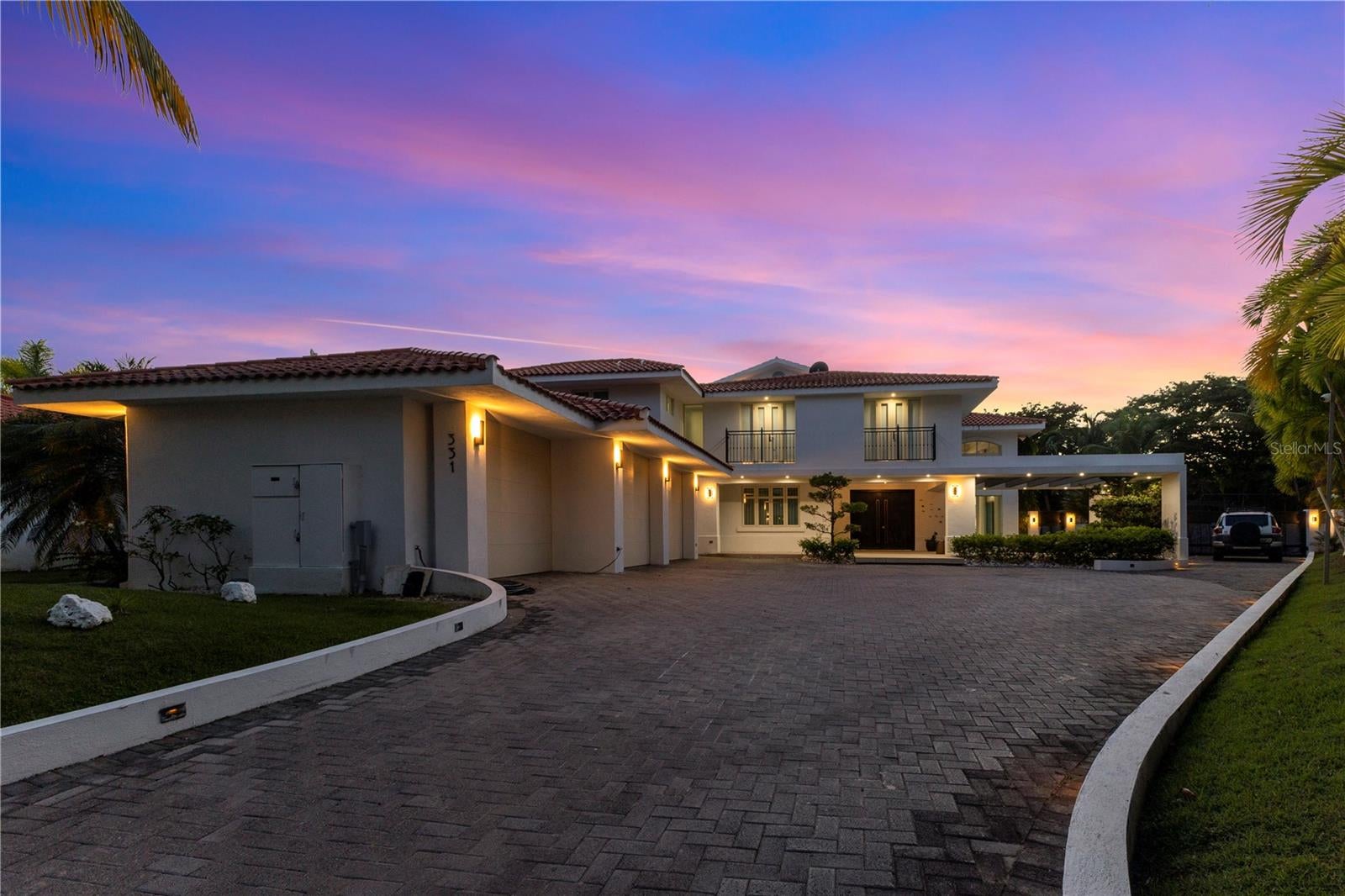 Behind the guarded gates of Dorado Beach East, on one of the largest lots in the community, this residence claims a rare footprint: 22,908 sq ft of land, 12,112 sq ft of total built area, and 7,932 sq ft of living space. Built in 2003 and held privately since, it sits on high ground outside the special flood hazard area, an increasingly scarce combination on Puerto Rico's north coast.

Inside, a sunlit foyer opens beneath a sculptural spiral staircase that anchors the home. The gourmet kitchen was built for someone who actually cooks, and it opens directly into the living and dining areas, which in turn flow out to the terrace so the entertaining space effectively doubles when the doors are open. Five bedrooms, each with its own en-suite bath, give every guest a private wing of their own. The primary suite goes further, adding a spa-inspired bathroom, a private mezzanine gym and a terrace of its own. With seven full baths and a powder room in total.

The outdoor space is the argument for the lot. A pool sits framed by mature tropical gardens, alongside a full outdoor kitchen and grill, with room left over for shade, seating and play. The house is equipped for real island living: a three-car attached garage , a cistern system, a whole-house generator and an integrated security system, so the property runs through storm season without improvising.

Dorado Beach East remains one of the island's most established guard-gated addresses. Residents have a private social club with pool, tennis courts, soccer field and park, and are minutes from world-renowned golf, the Dorado Beach Ritz-Carlton Reserve and the beaches that made Dorado what it is. HOA $1,095 monthly. CRIM: 12,656 annually. Garage: Yes | Attch: Yes | Spcs: 3
Showings by appointment.