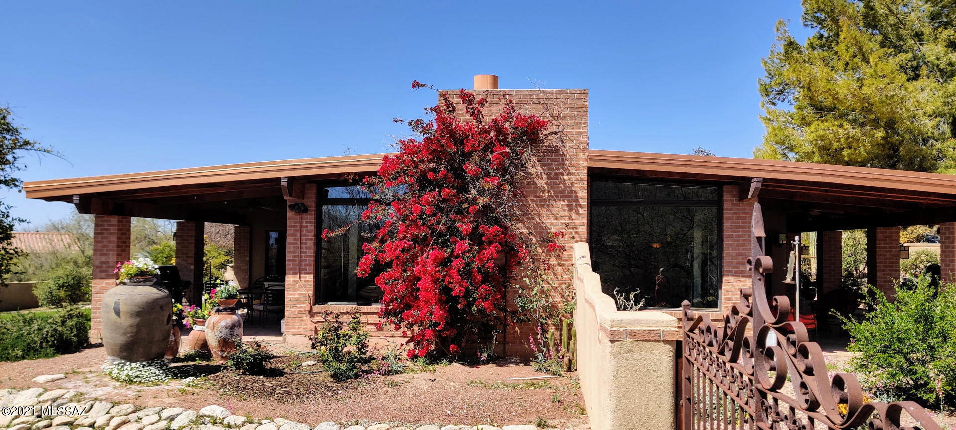 Sabino Canyon oasis remodeled with a new dining room, upgraded kitchen, and three renewed bathrooms. Fireplaces in living and family rooms. Telecommuters love the quiet office. A guest room with twin Murphy beds.

Hundreds of trees. Three ponds, the largest at 60,000 gallons with a waterfall. An onsite well feeds ponds and irrigation. Gardener and irrigation team available for new owners.
 
A large yard with Bougainvillea-covered walls. Grapefruit trees and a lemon tree. A sanctuary garden, under a spreading Mesquite, includes an iron table for 12, with an adobe fireplace.
 
The dead-end street sits near a primary school and beautiful Sabino Canyon State Park. 5 minutes from restaurants, a stores, and an art gallery.