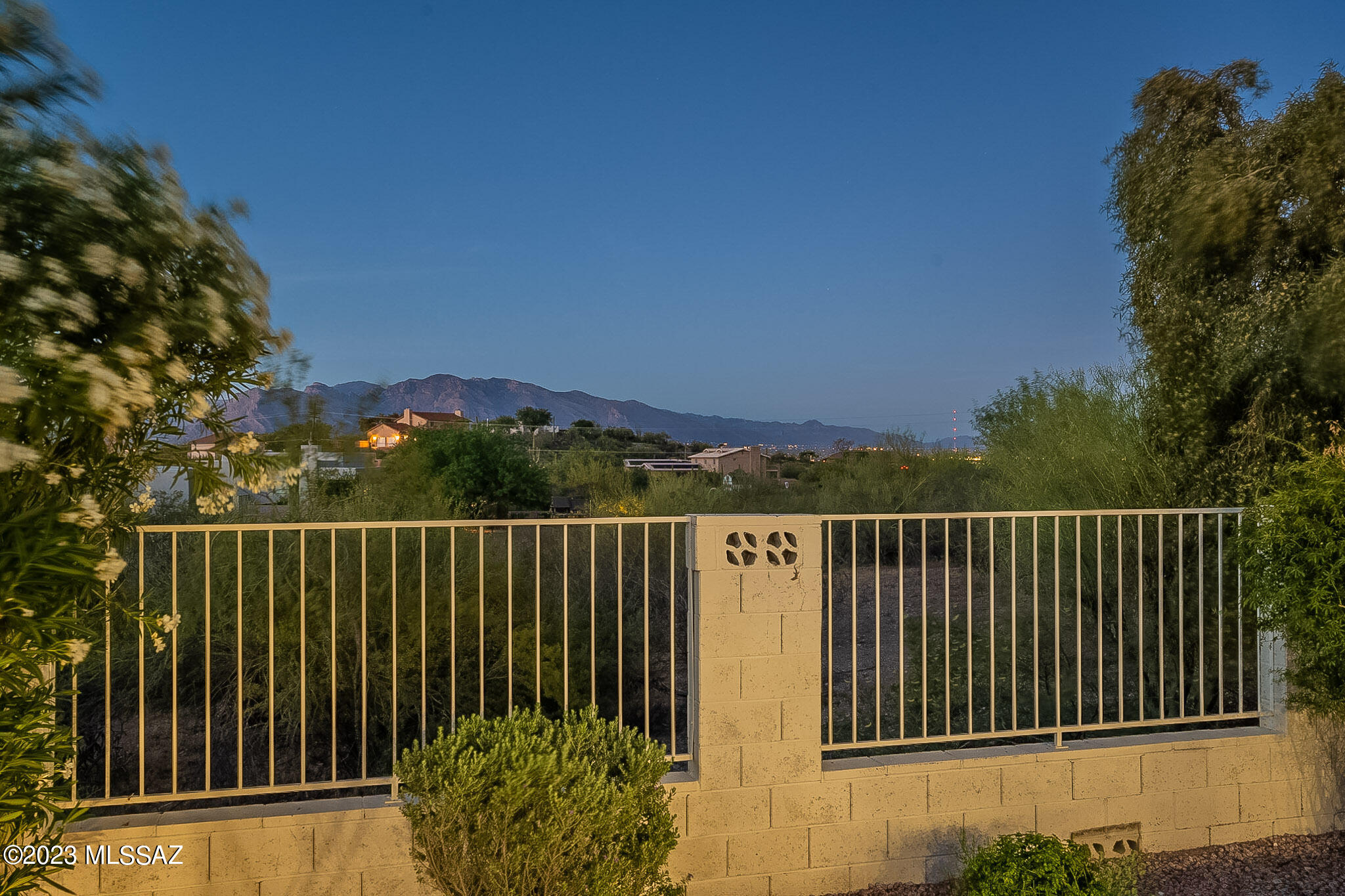 SELLER WILL CONSIDER OFFERS PRICED 500K - 515K. Stunning Tucson Ranch w/ Privacy & Views sitting on just over an lush acre that backs up to a wash w/ beautiful mountain views, stunning sunsets & city lights. Low care front yard & gorgeous backyard with full covered patio, pavers, side yard & artificial turf. Kitchen has just had a facelift with gorgeous greyish-blue cabinets, new hardware and quartz-like counters - Huge walk-in pantry.  Beautiful wood beams running across the vaulted ceilings and warm saltillo flooring. 3 large bedrooms, 2 baths, over sized 2 car garage plus huge workshop, man door & extra storage.  Bonus dual pane windows. Feels like you are on your own remote island - with fantastic cul-de-sac location.