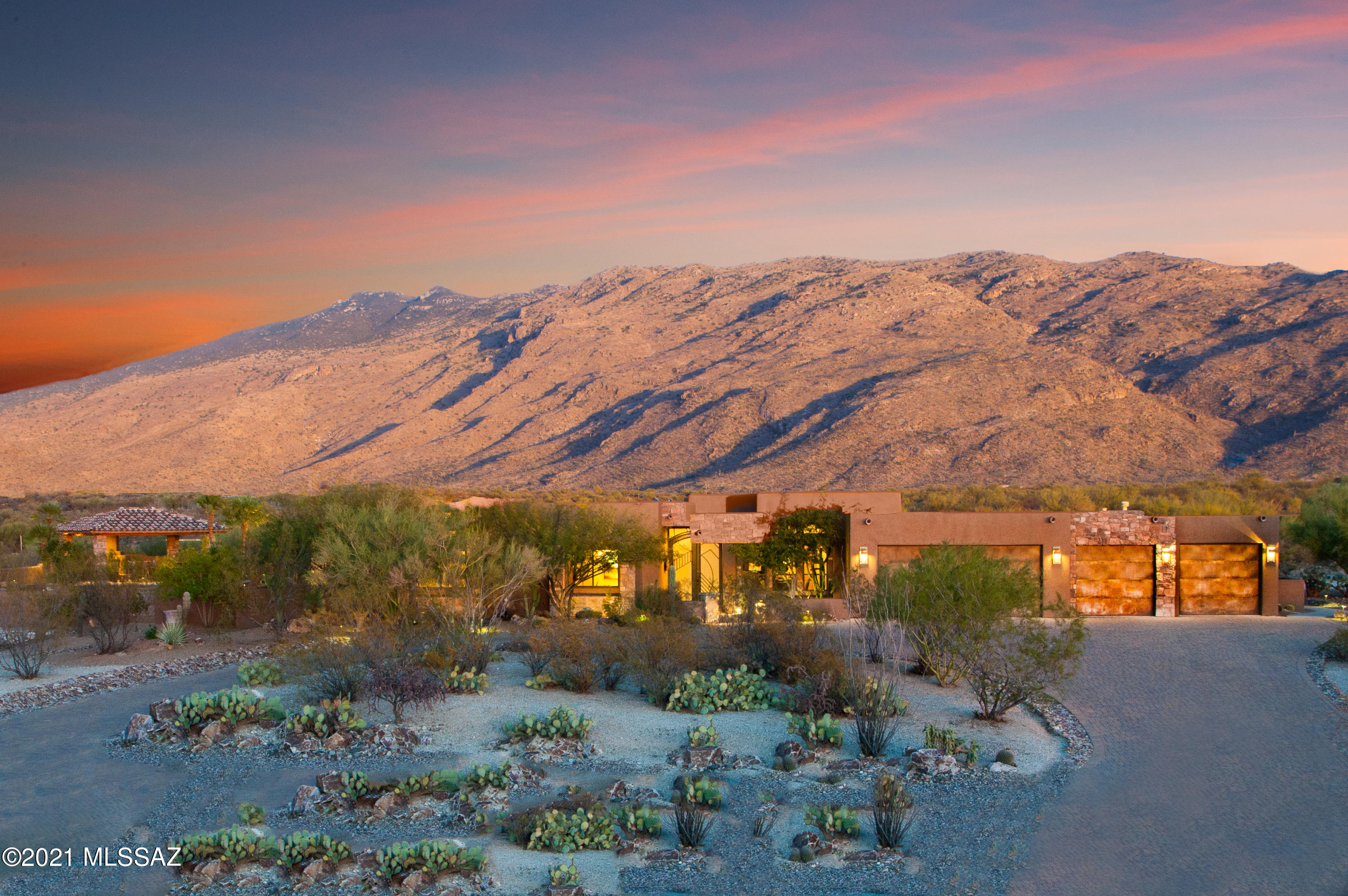 Award Winning Masterpiece located across from the Saguaro Monument National Park. Custom Built by Tucson Premier Builder TRS Custom Homes. Custom Quality abounds from the flagstone flooring, soaring ceilings,  large family room with floor to ceiling windows framing the Catalina Mountains. Staked Stone f/p. Chef's kitchen with custom appliances, granite counters, large island, nook. Formal living room with custom ceiling, door leading to second patio. Formal dining room with trayed ceiling. Custom powder room.  Owner's suite with bonus room and exquisite bath area, jetted tub. secondary bedroom en-suite bath. Pool bath with granite counters, banco seating. Backyard with large lap pool/spa, custom fireplace, Ramada, outdoor kitchen, staked stoned columns, grass area, professionally landscape Second yard with views of the Rincon Mountains, outdoor fountain, professionally landscaped. Guest quarters with private bath, separate entrance, large closet area, perfect for home office. Tanque Verde School District.