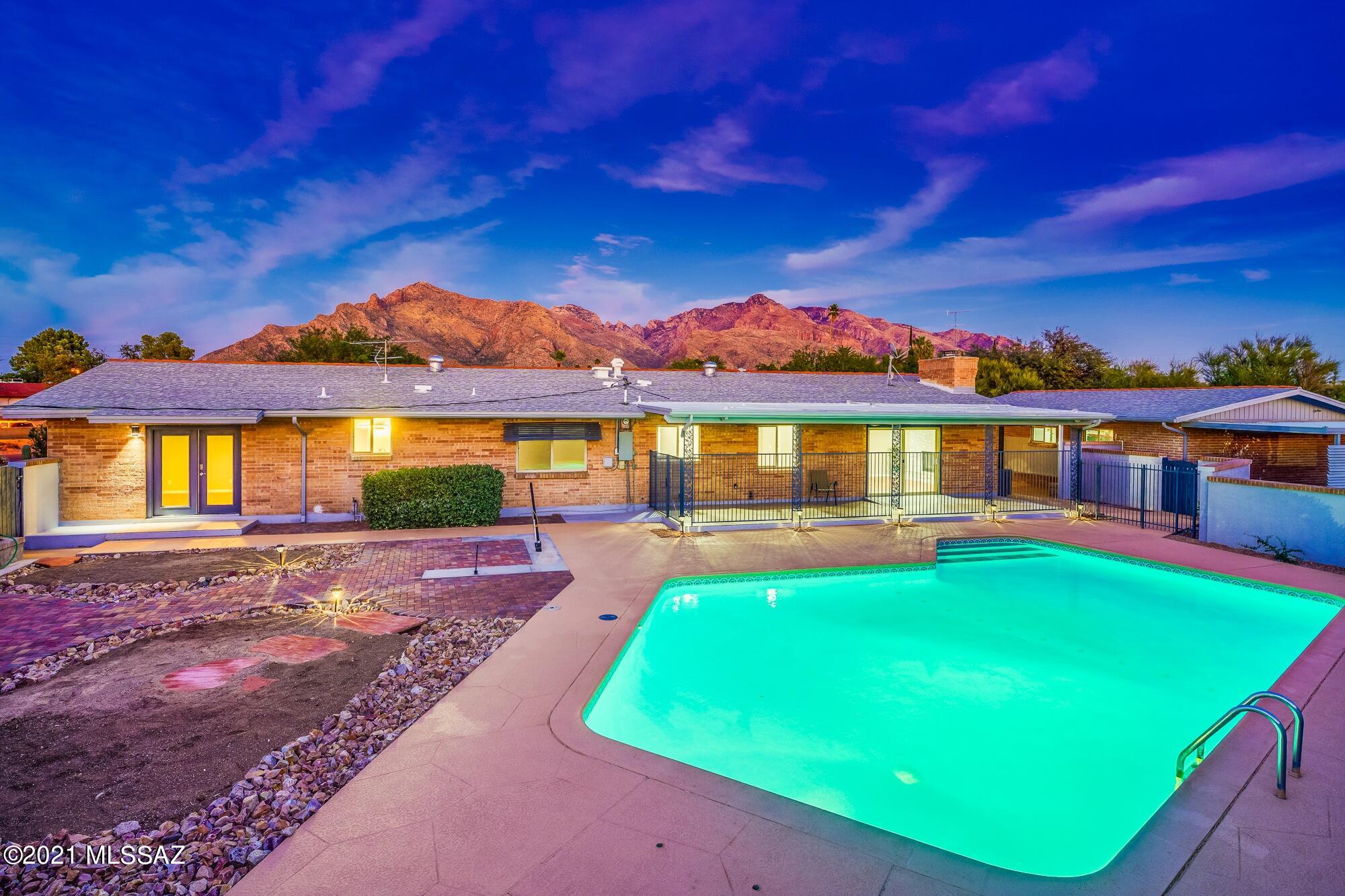 Range priced $875,000-$925,000. Amazing remodeled mid-century double red brick home in highly sought after Casas Adobes subdivision. Location, location, location! This home is one of the premier locations in Tucson. Walk to high end restaurants in Casas Adobes Shopping Center, Trader Joe's,  Wildflower, Stqrbucks Whole Foods, just to name a few.. Enjoy a short commute to downtown, U of A and I-10. Attention to detail has been paid throughout this incredible, better than new home. Huge 1.22 acre lot with plenty of room for guest house or RV garage. Enjoy the amazing home theatre room which is also perfect for home schooling. Peaceful breezeway is an extended outdoor entertaining area. Ramada, barbeque area and extensive covered patio. Built in 1968 but redesigned for today's most discriminating buyers. Open kitchen with new contemporary kitchen, granite counter tops, custom backsplash, ambient lighting and stainless steel appliances. Stone accents throughout the home tie in beautifully with the natural stone fireplace. The bathrooms have been designed with an ''at home spa'' feel.