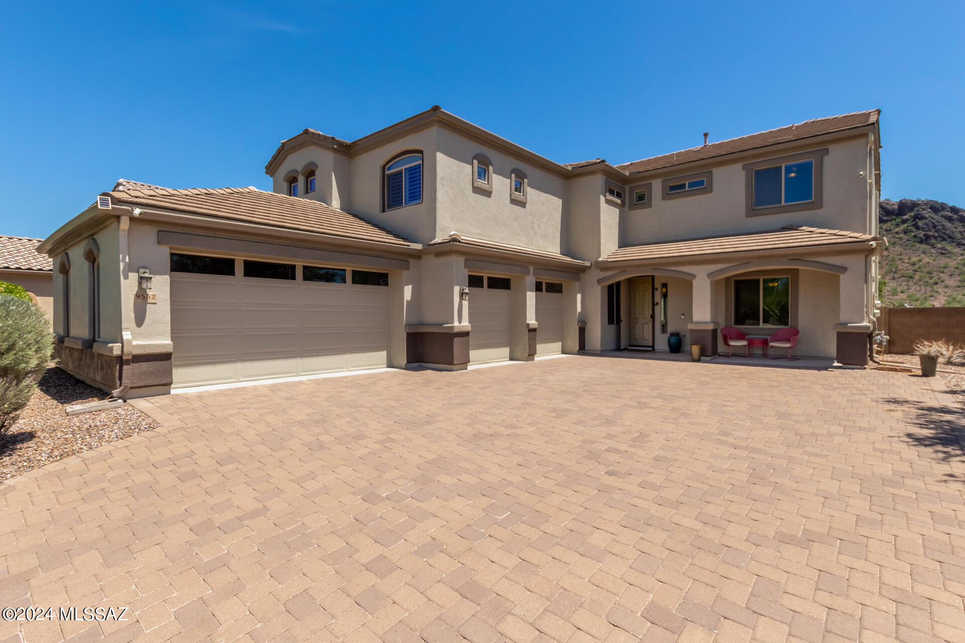 Your dream home is finally here! Discover this exquisite residence featuring a 4-car garage, an expansive paver driveway, and a welcoming front porch. The living room boasts high ceilings, a neutral palette, classic plantation shutters, and elegant wood-look flooring. The formal dining room is perfect for memorable dinner gatherings. The delightful kitchen is equipped with granite counters, ample wood cabinetry with crown molding, a stone tile backsplash, pendant/recessed lighting, stainless steel appliances, a pantry, and an island with a breakfast bar for casual dining. You'll also find a den ideal for an office or study. Upstairs, the sizeable loft adds a versatile space for leisure or entertainment. The cozy main bedroom offers plush carpeting, direct balcony access, a chic wood feature wall, an ensuite with dual sinks, and a walk-in closet. Relish the breathtaking mountain views from the spacious balcony. The enchanting backyard features a full-length covered patio, low-maintenance artificial turf, a charming gazebo, a built-in BBQ, and a refreshing pool for cooling down on hot summer days. Make this gem yours now!