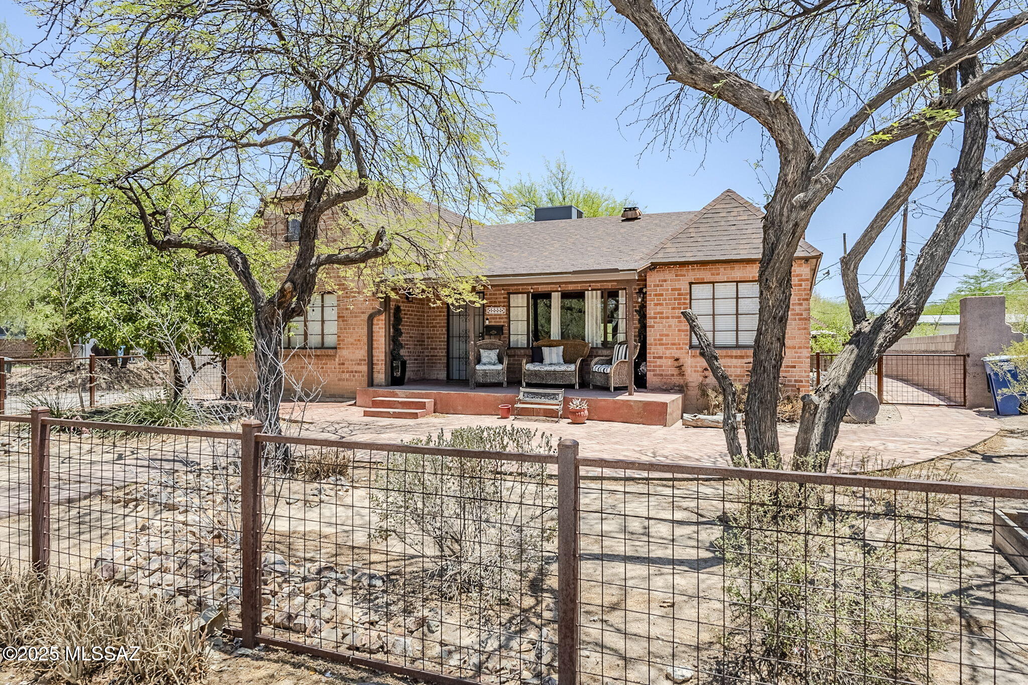 A stunning Tudor Revival residence built in 1948, nestled in the coveted Feldman's Historic District—just under a mile from the University of Arizona and downtown Tucson. This home effortlessly blends historic charm and modern amenities amid a vibrant community. With the classic Tudor Revival architecture, original hardwood floors and thick stucco-over-brick walls. Bonus spaces including a library, loft, office, rec room, and finished basement perfect for entertaining or multi-generational living. Primary suite located on the main level for convenient convenient one-floor living. Fully paid-off solar system and rainwater harvesting setup, enhancing energy and water efficiency in the desert! Detached 2-car garage and four off-street parking spaces.  Also Owned Solar!!