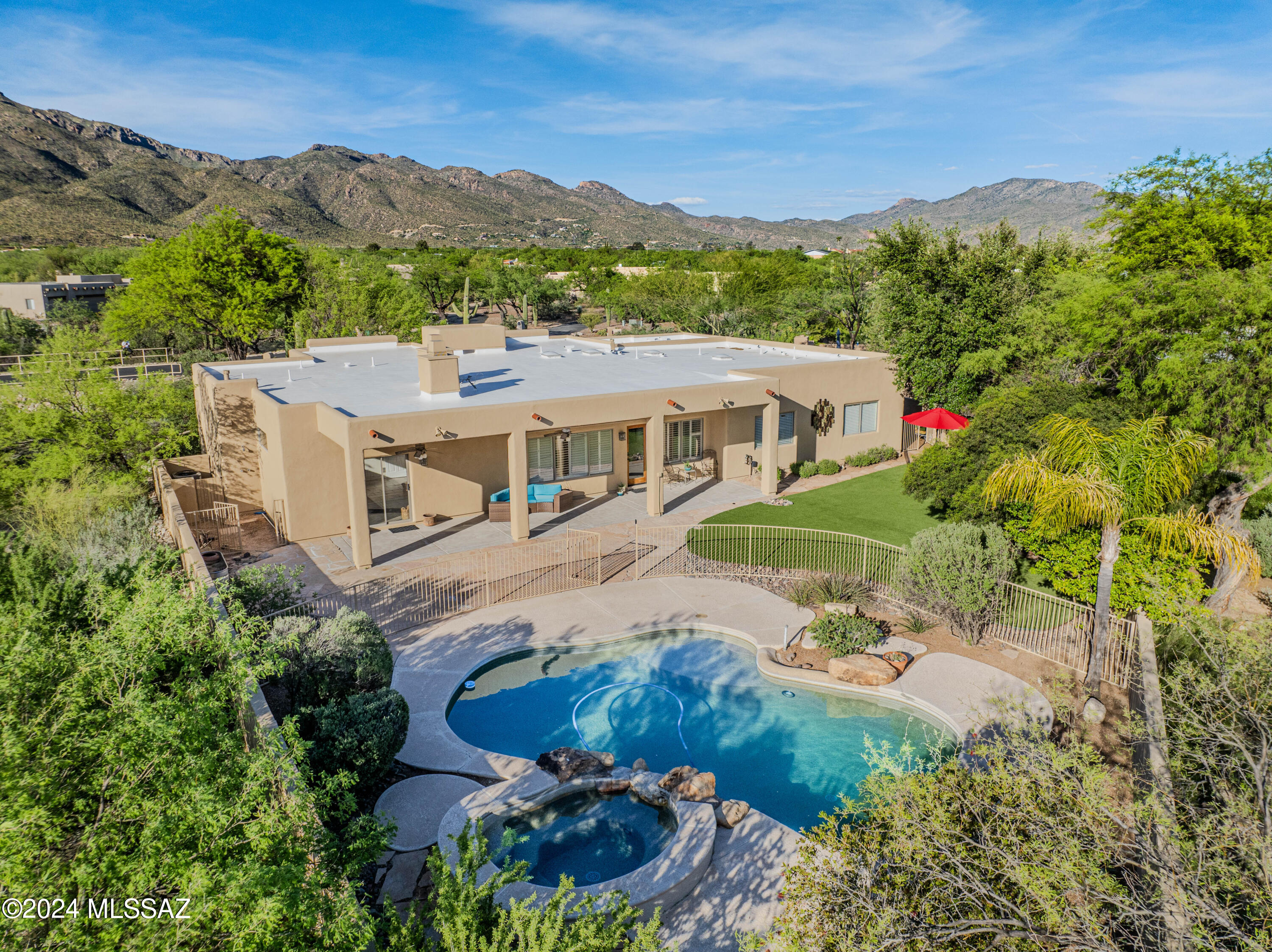 Exceptional, contemporary custom home! Nestled next to the Catalina Mountains on a large, private lot. Your next home awaits! Soaring, vaulted ceilings in every room, walls of north facing windows provide majestic mountain views. Desert buffer is part of your nearly one acre lot. Expansive 4 bedroom with split bedroom plan, contemporary stone fireplaces in great room and master bedroom, completely walled yard with massive patio, pebble tech pool and inground spa with rock water feature. Chef's kitchen with granite countertops, solid maple cabinetry and all brand new stainless steel appliances and large walk-in pantry, travertine floor with new luxury carpet in the bedrooms, formal dining room, dedicated north facing office with french doors to a private patio.