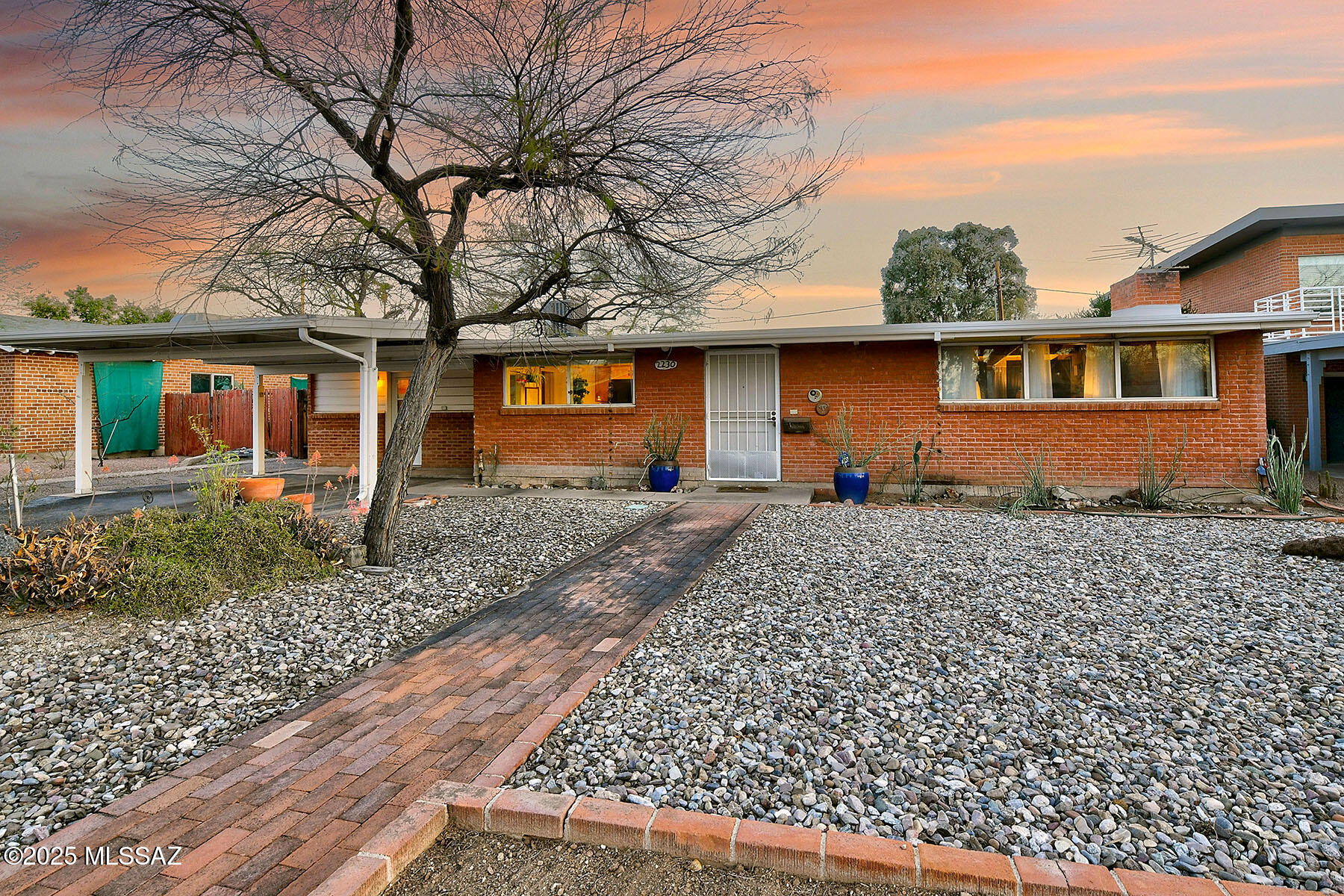 This well-preserved mid-century modern gem in the heart of Sam Hughes exudes character and potential. A true modernist treasure, this home invites restoration while showcasing its timeless architectural details—vaulted boxed wood ceilings, exposed brick walls, and original vintage bathrooms. The thoughtfully updated kitchen and spacious mudroom/laundry room enhance functionality, while the flexible floor plan includes 2 bedrooms, 2 bathrooms, and a versatile den. Expansive walls of windows frame serene views of the private, walled backyard, creating a seamless indoor-outdoor connection. A two-car carport adds convenience, and as a contributing property on the National Historic Register, owner-occupants can benefit from a 35-45% tax credit reduction. Ideally located within walking distanc walking distance, of the University of Arizona, Himmel Park, and a variety of dining options, this home is an exceptional opportunity to restore and revitalize a true architectural classic.