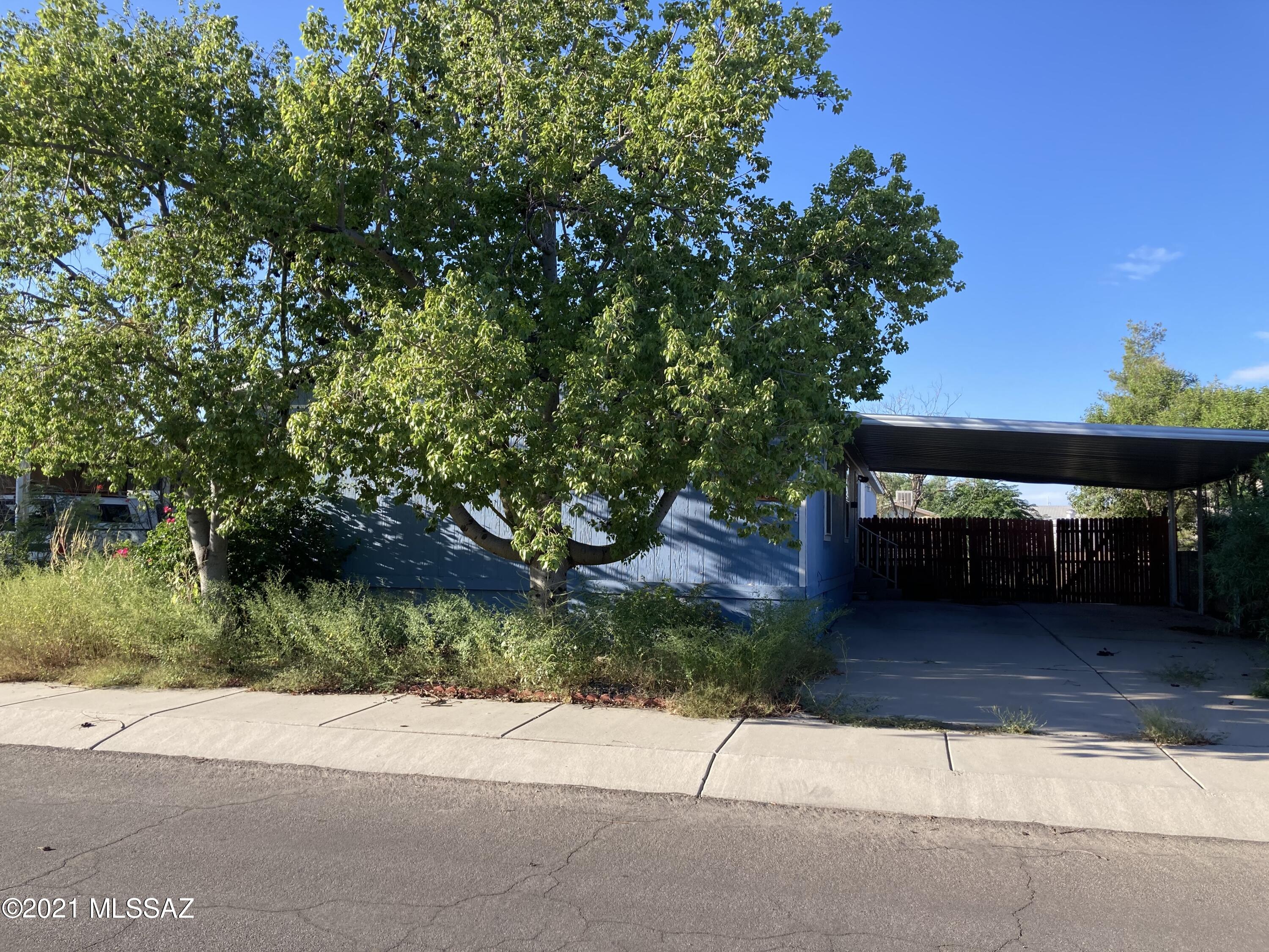 Wow - 4 bedroom, 2 1/2 bath - formal living room and dining room plus huge family room with fireplace - handicapped accessible - wheelchair ramp, oversized access door, roll in shower and roll in undercabinet  - all in an over 2000 sq ft Affixed Manufactured Home in a gated community.