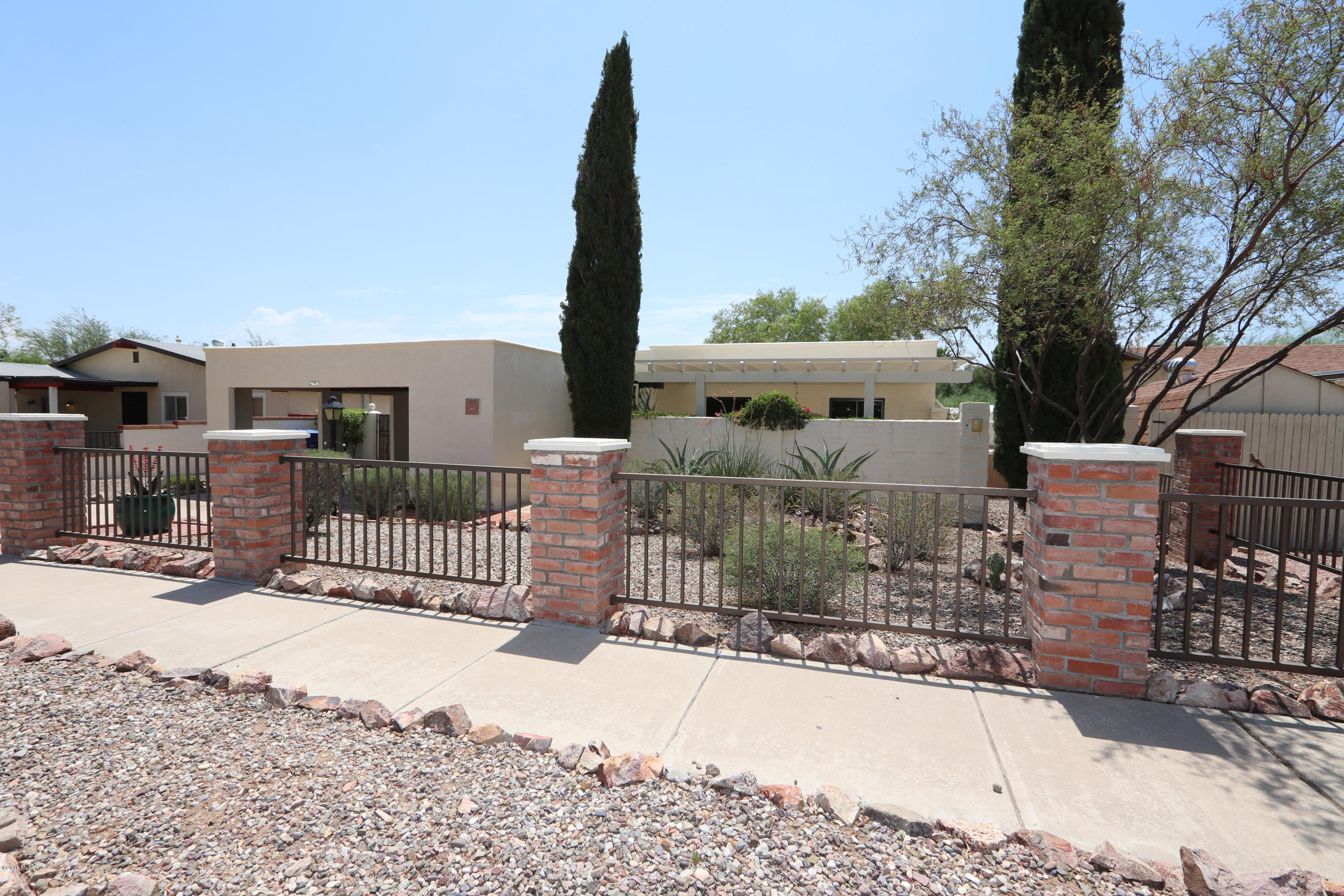 Sensational beauty in desirable Westside community with No HOA.  You will fall in love with unique tile and touches throughout. Added bonus with installed Security screens. Gorgeous landscaping,  relaxing backyard, covered patios..... an oasis awaits you.  All pots and plants convey with sale. Agent owned. A must see.