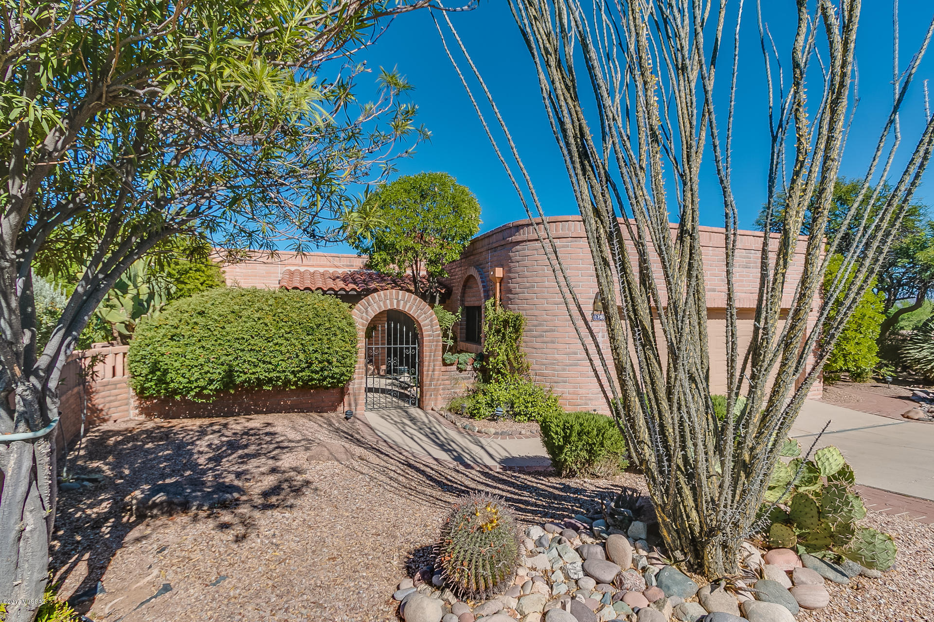 This beautiful Canoa Estates home is nicely positioned atop a ridge offering stunning panoramic views of the mountains and desert landscape below.  The popular Senita model offers 1794 Sq. Ft of living space including; two bedrooms, two bathrooms, a den, formal dining space and large living area complete with bee hive gas fireplace.  The kitchen offers ample natural light and terrific views of the Santa Rita mountains from the sink and breakfast nook.  You will love the beautiful wrap around paver patio that can be accessed from the many sliding doors throughout the home.  A neutral tile in all the right places and new carpet has been installed making this home move in ready.