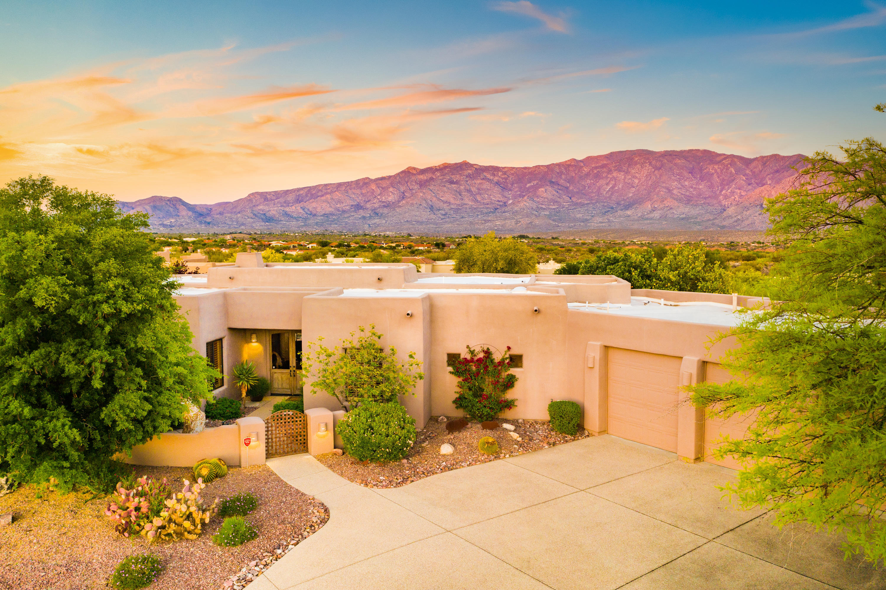 Simply delightful and inviting great room style home in the gated Estates at High Mesa! Enjoy panoramic views of the Catalina Mountains from your large covered patio with automatic rolling sun screens to keep you cooler in the summer and warmer in the winter. Pool and spa with in-floor cleaning plus Kiva fireplace and built-in BBQ offer the best of AZ's outdoor lifestyle! Floor to ceiling windows showcase the marvelous Catalina views from the great room with stone-faced fireplace and all tile floors throughout public spaces & Master. Kitchen amenities include dovetail cabinetry, granite, prep island w/sink, Dacor gas cooktop w/hood, Dacor oven & M/W plus Bosch D/W. In addition to Master Suite w/Kiva Fpl & direct patio access, there are 2 guest suites, office, rec rm and large 3-car garage!