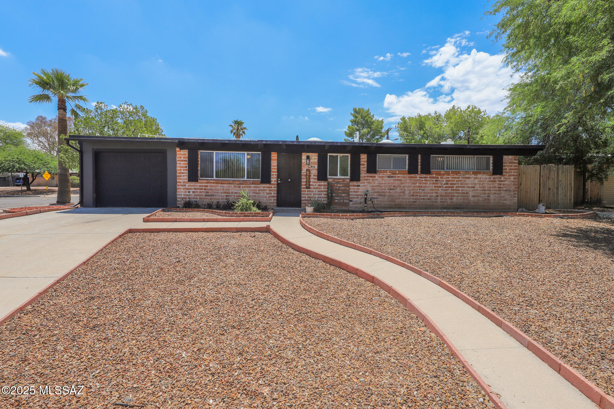 **No cats
This updated home is full of character and comfort, ideally situated on a spacious corner lot with extra parking for vehicles or toys. Enjoy a north-facing backyard perfect for Tucson living, featuring a refreshing pool, extended covered patio, and a cozy outdoor fireplace—ideal for entertaining or relaxing year-round.
Inside, you'll find vaulted ceilings with exposed wood beams, new hard surface flooring throughout, and a beautifully updated kitchen with stainless steel appliances, an oversized butcher block island with seating, and modern finishes. The home also includes a new A/C system, attached garage, and stylish touches throughout.
A unique find in a great location convenient to shopping & restaurants.