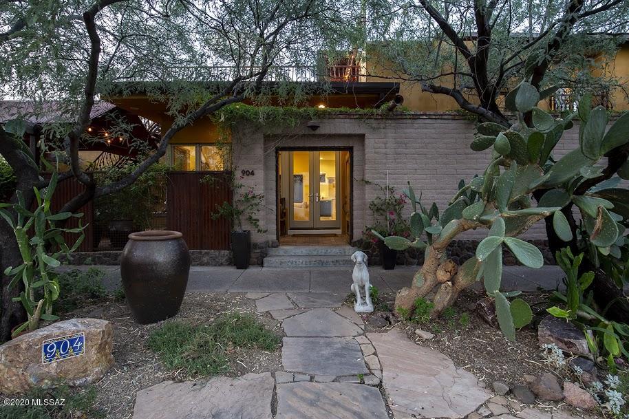 Absolutely stunning two-story home in the Mercado, with views of the city and the mountains from gorgeous rooftop deck.  This home has been updated with a fully remodeled gourmet kitchen featuring a Wolf range, Dacor fridge, Bosch dishwasher, and imported carrara marble countertops,  also remodeled master bath.  Floors are polished concrete, refinished a sophisticated white in 2018.  The light is just gorgeous in this home, and it is so private, with beautiful landscaped courtyards, thriving vines and plants,  surrounded by adobe walls.  The neighborhood features lovely gathering spots, cafes and shopping right there, in the Mercado and Annex! Stroll over for a pastry and coffee, or to catch the Modern Streetcar to head downtown or to the UA. This is the life! 3D tour & floorplan attached.