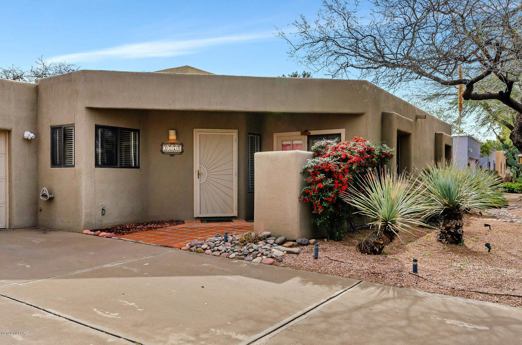 This charming nugget is in a prime Tucson mid-town location! It boasts 4 BR, (4th bedroom currently used as a Den), 2 bath, with 2 car garage. Oversize eat-in kitchen with breakfast bar and stainless steel appliances! Backyard has built-in grill,  and large concrete fire pit for festive entertaining. Great room with wood burning fireplace and soaring ceilings. Sitting room (or multipurpose room) off Great Room. Gates on both side of the home allow for easy access to rear yard to store your toys etc. Located close to the Tucson Racquet Club and the River Walk.   Floor plan located under documents