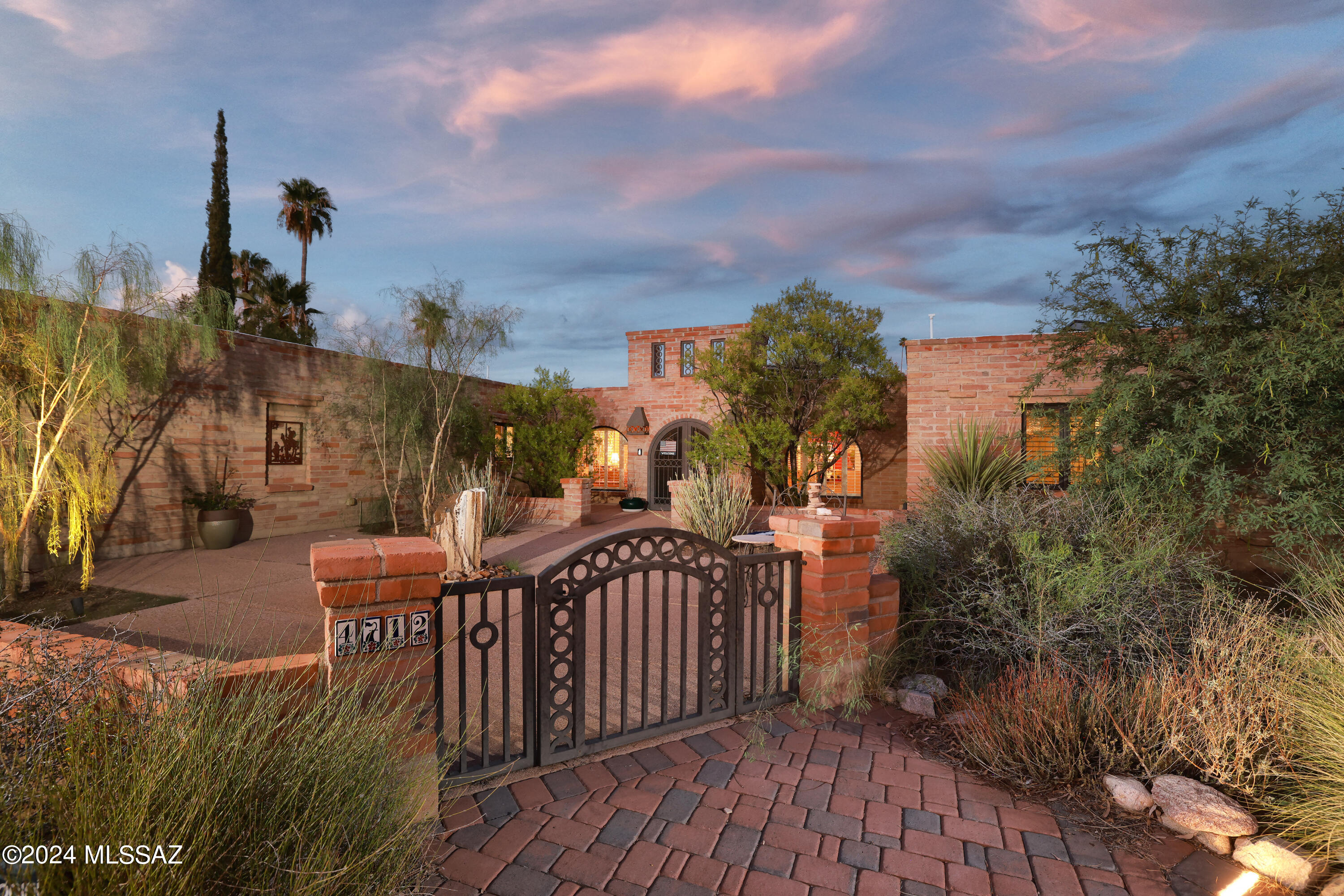 Absolutely fantastic burnt adobe home sitting on over half an acre lot that backs to a lush desert wash with enormous mesquite trees and rolling sahuaro studded hills that afford a high level of privacy in a tranquil environment. The 100% remodeled kitchen is guaranteed to exceed expectations with its large butcher block island; stainless Miele brand convection oven, induction cooktop, and dishwasher; LG refrigerator/freezer; coffee bar area adjacent to the breakfast nook with stainless wine frig.  The home features natural stone floors, exposed beams, Pella sliding doors & windows, plantation shutters, and a flowing floorplan.  The rear yard and patio feature a fantastic space for entertaining or private relaxation in solitude.  Water harvesting and solar for the environmentally minded.